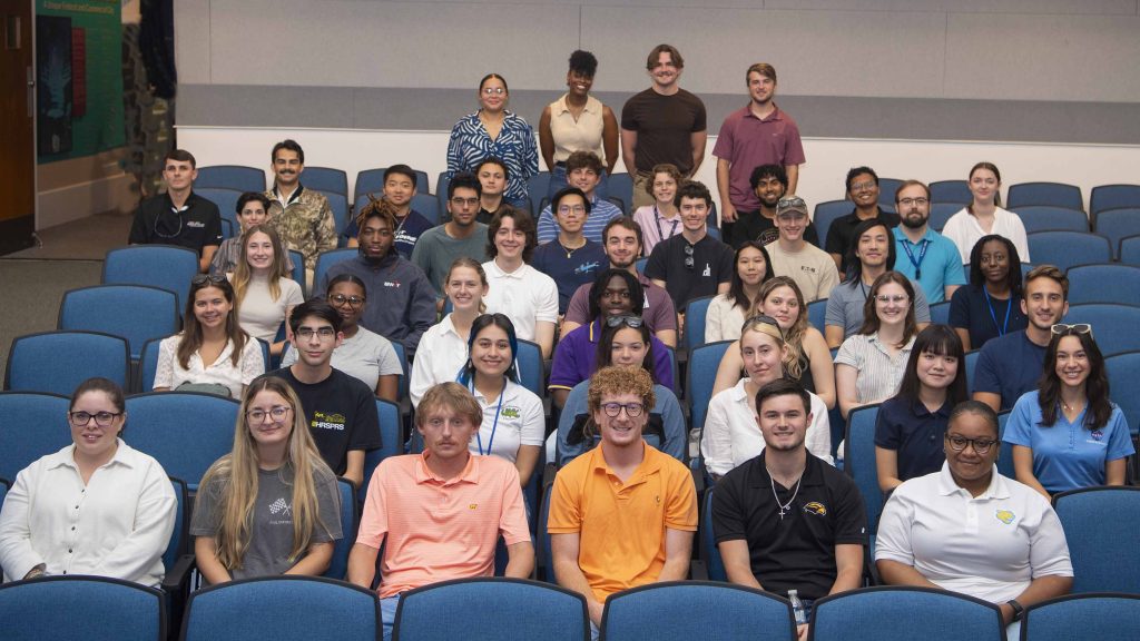 Interns representing NASA and companies across the NASA Stennis federal city pose for a group photo inside StenniSphere in honor of National Intern Day.