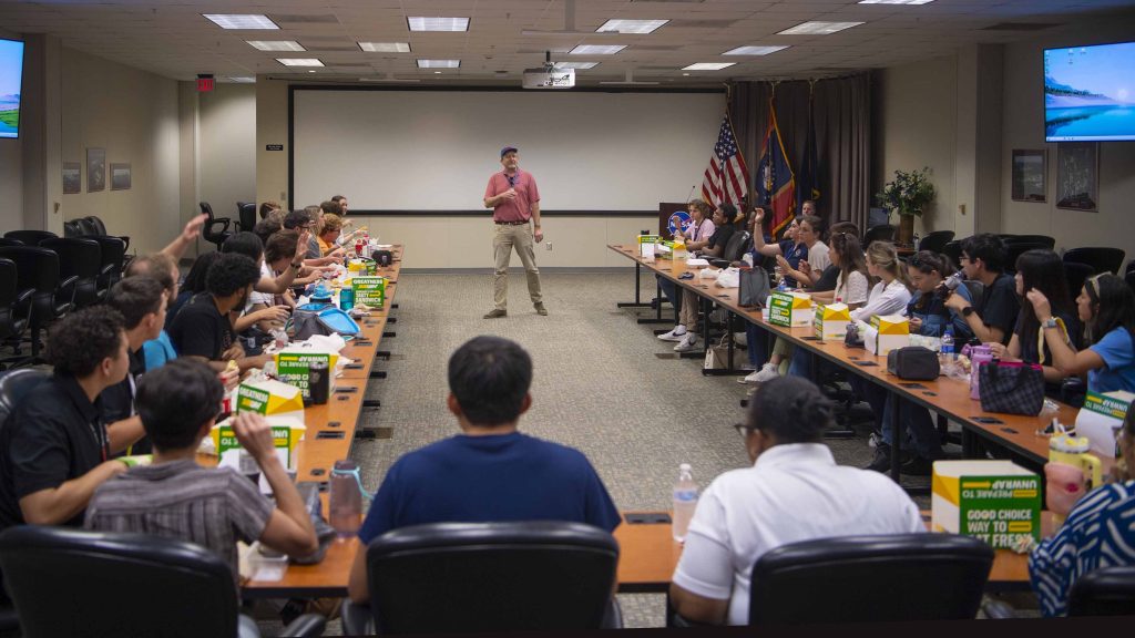 NASA Stennis Associate Director Rodney McKellip stands before a room filled with NASA interns