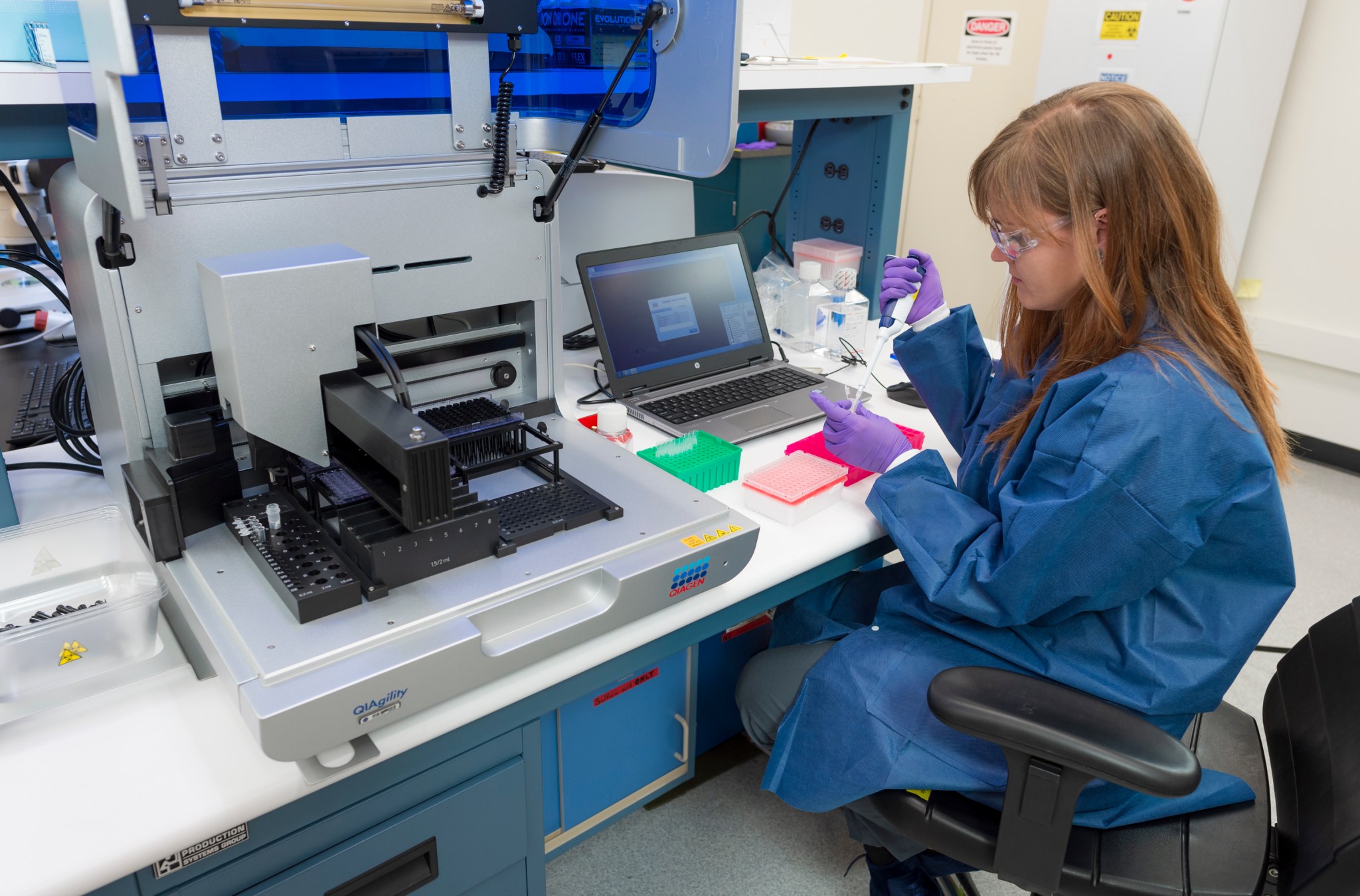 A female in a sample lab taking samples