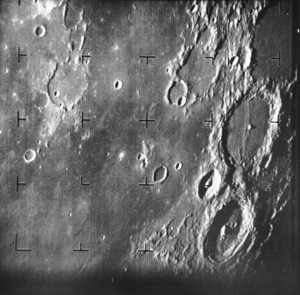 Ranger 7's first image from an altitude of 1,311 miles - the large crater at center right is the 67-mile-wide Alphonsus