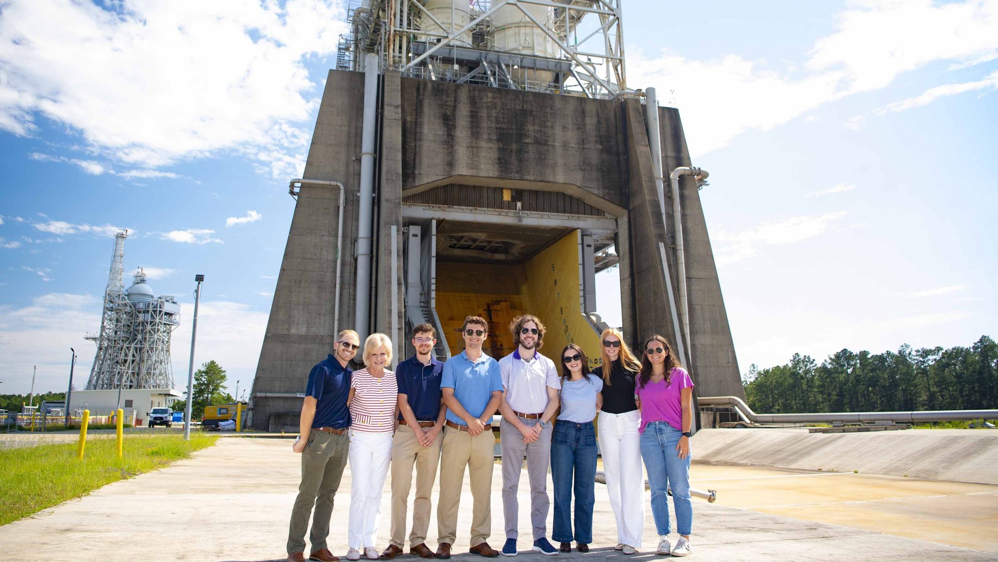 Legislative staff and interns from the office of U.S. Rep. Garrett Graves of Louisiana stand in front of the Fred Haise Test Stand.