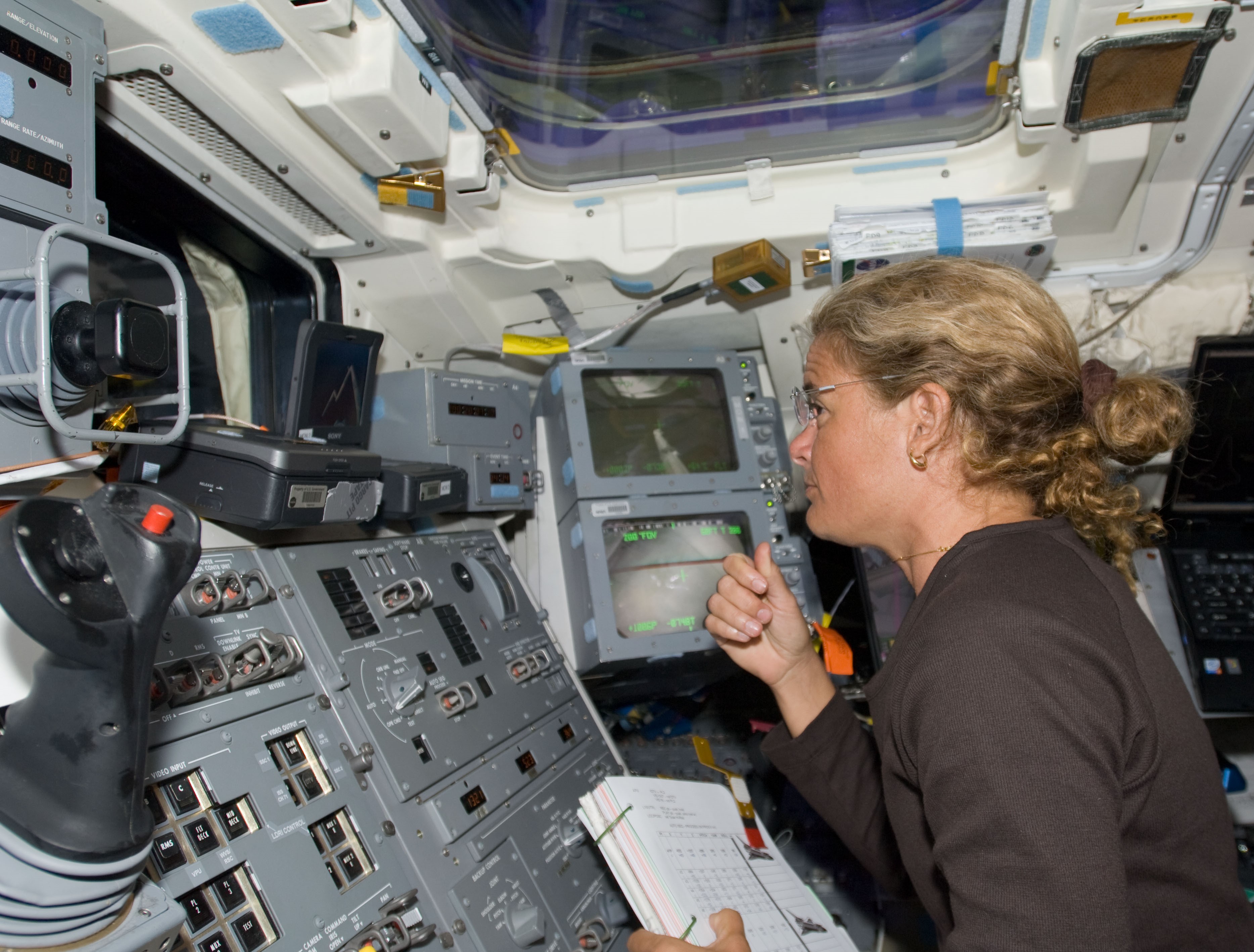 Canadian Space Agency astronaut Julie Payette operates the SRMS during the TPS inspection