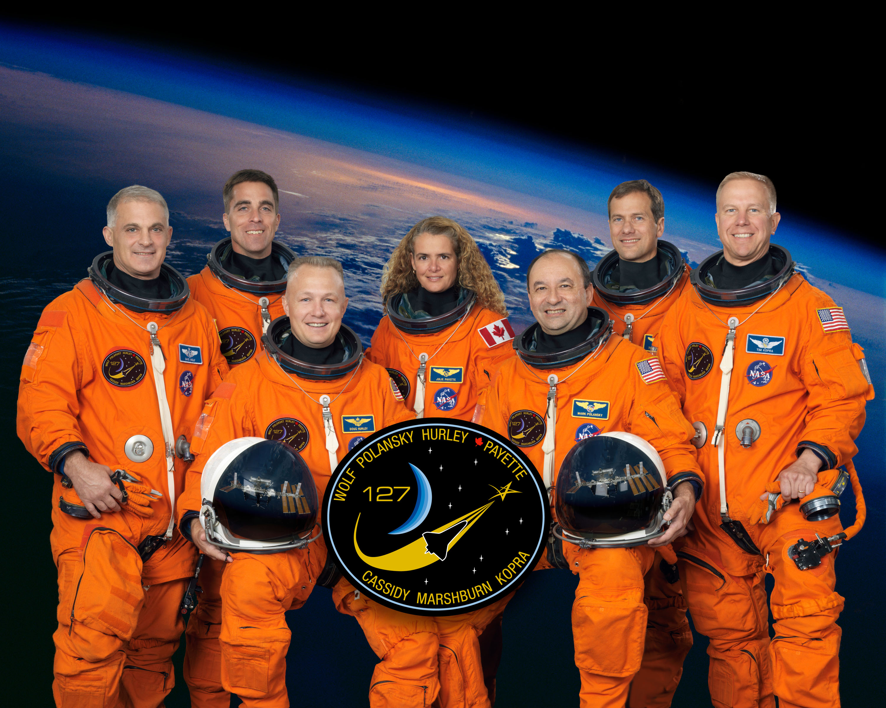 Official photograph of the STS-127 crew of David A. Wolf, left, Christopher J. Cassidy, Douglas G. Hurley, Julie Payette of Canada, Mark L. Polansky, Thomas H. Marshburn, and Timothy L. Kopra