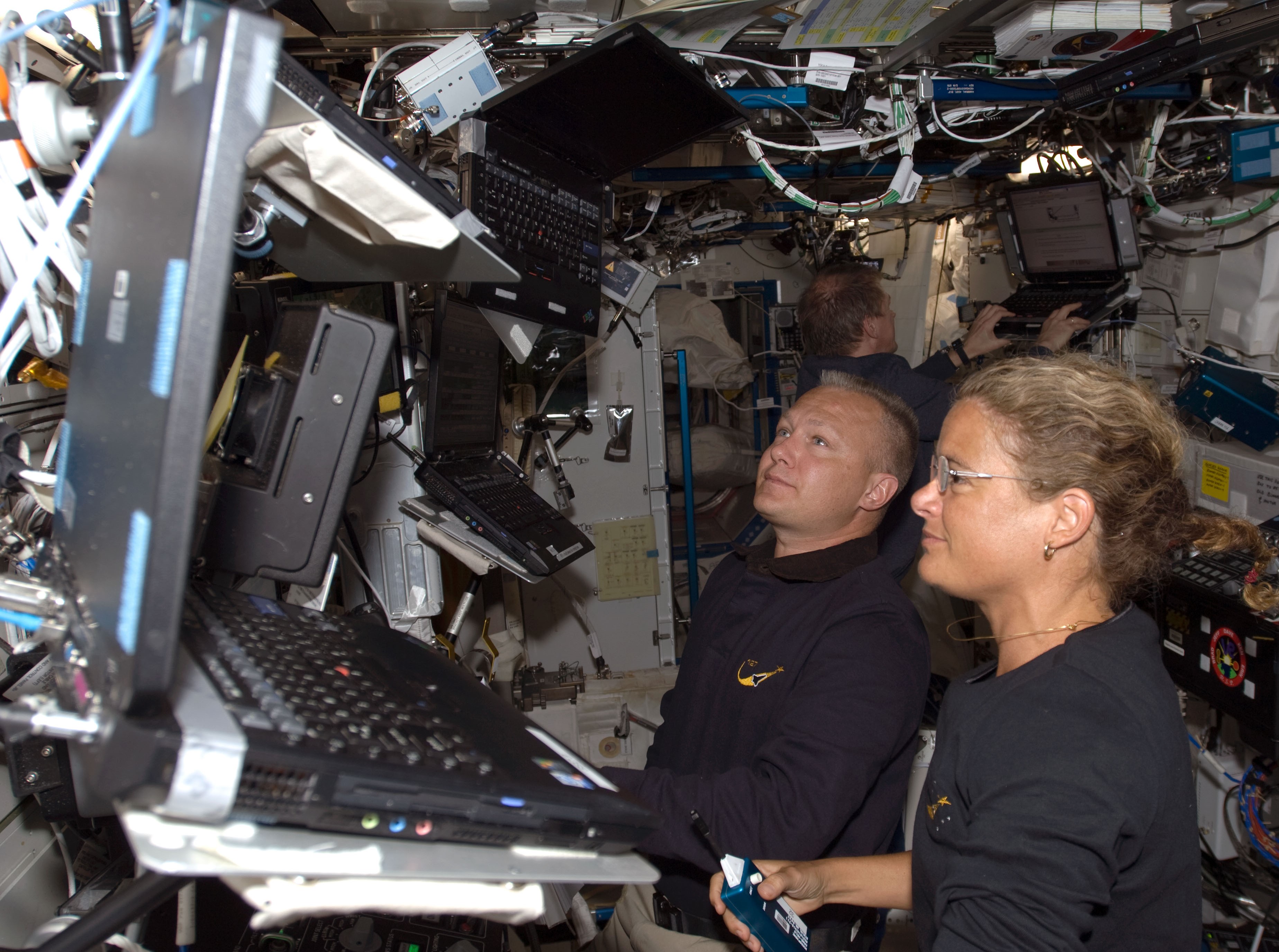 NASA astronaut Douglas G. Hurley, left, and Canadian Space Agency astronaut Julie Payette operate the station's robotic arm during the second spacewalk