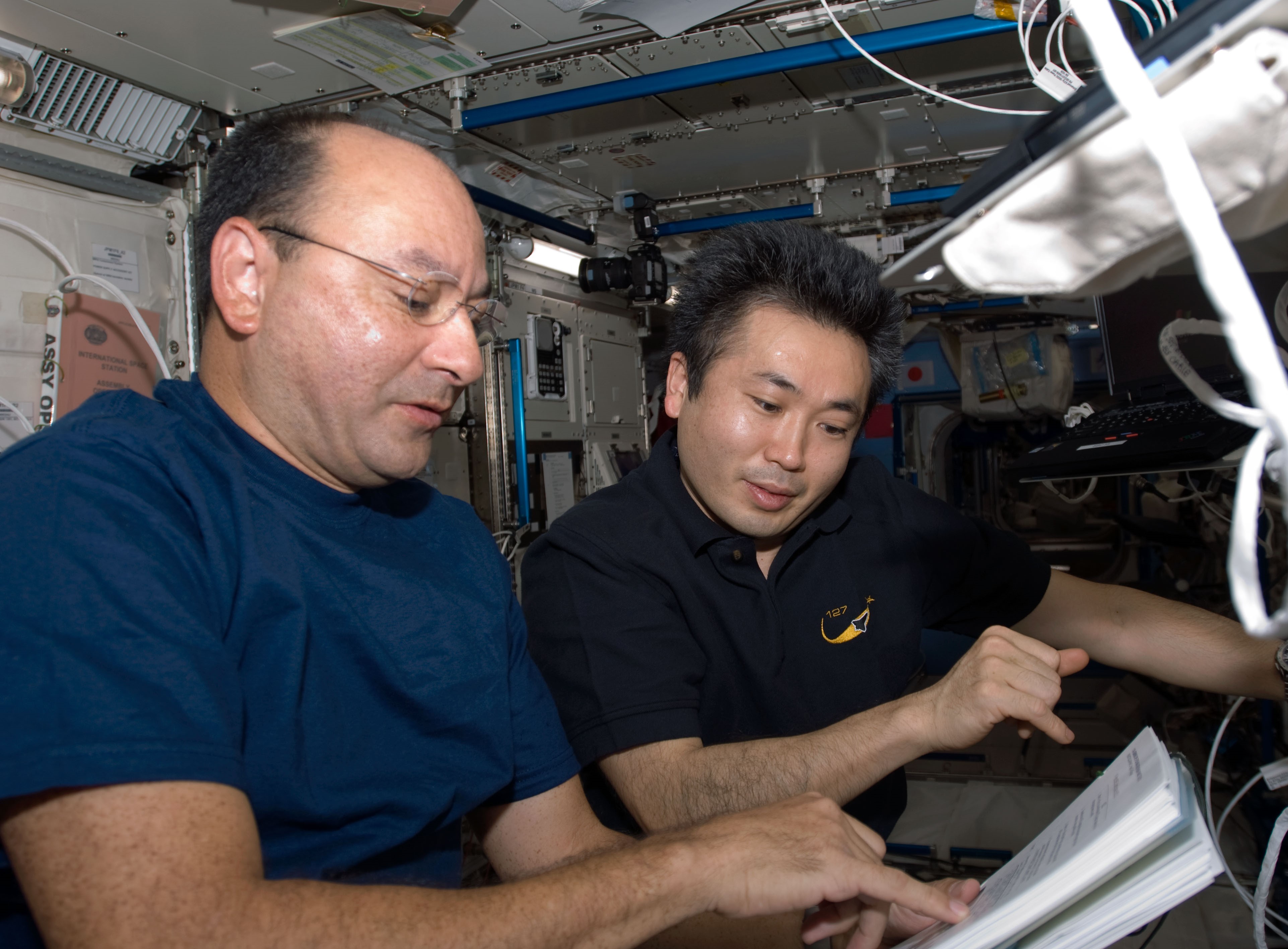 Mark J. Polansky, left, and Koichi Wakata of the Japan Aerospace Exploration Agency, one of the three teams that transferred the EF payloads using Kibo’s robotic arm