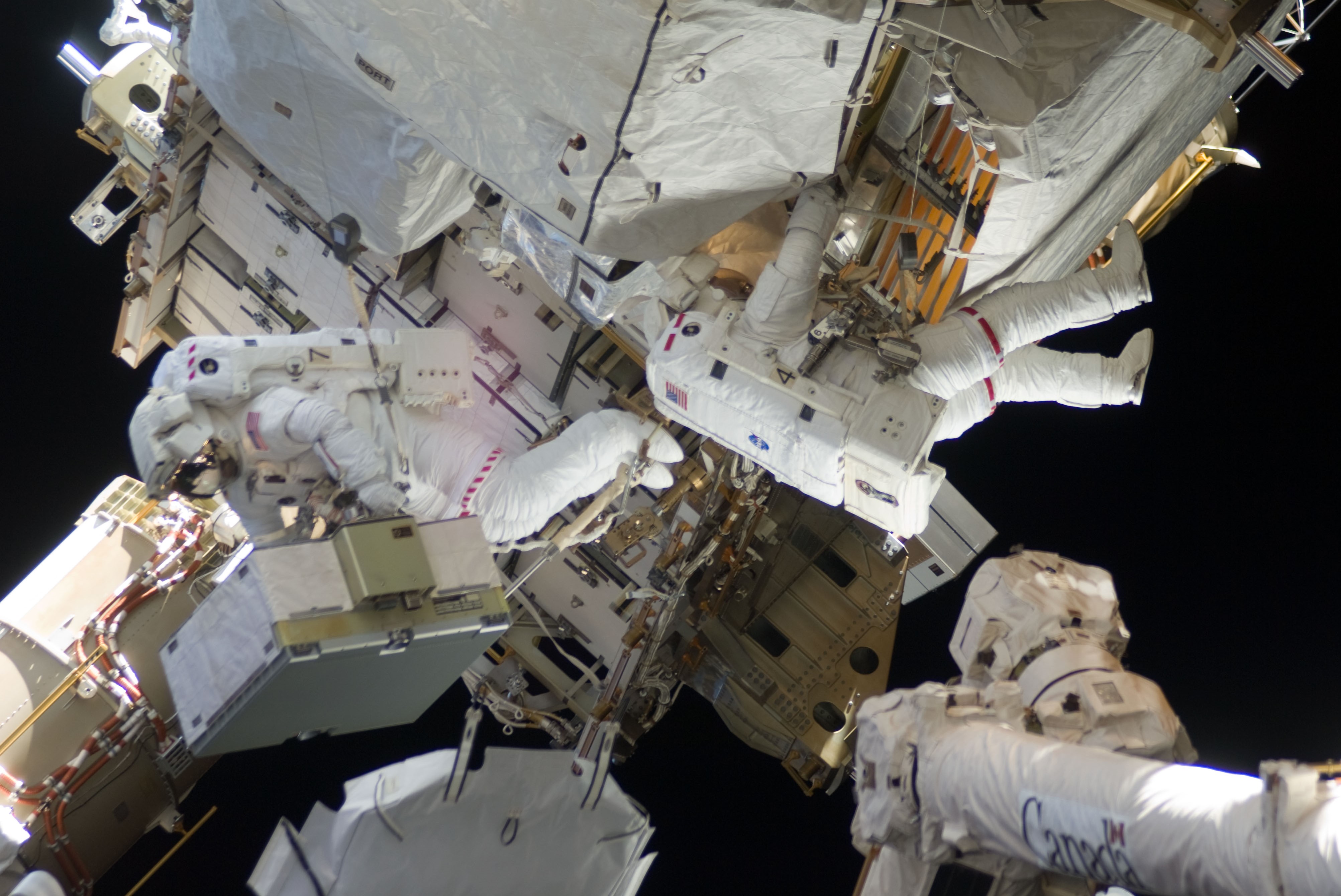 Christopher J. Cassidy, left, and Thomas H. Marshburn exchange space station batteries during the mission's fourth spacewalk
