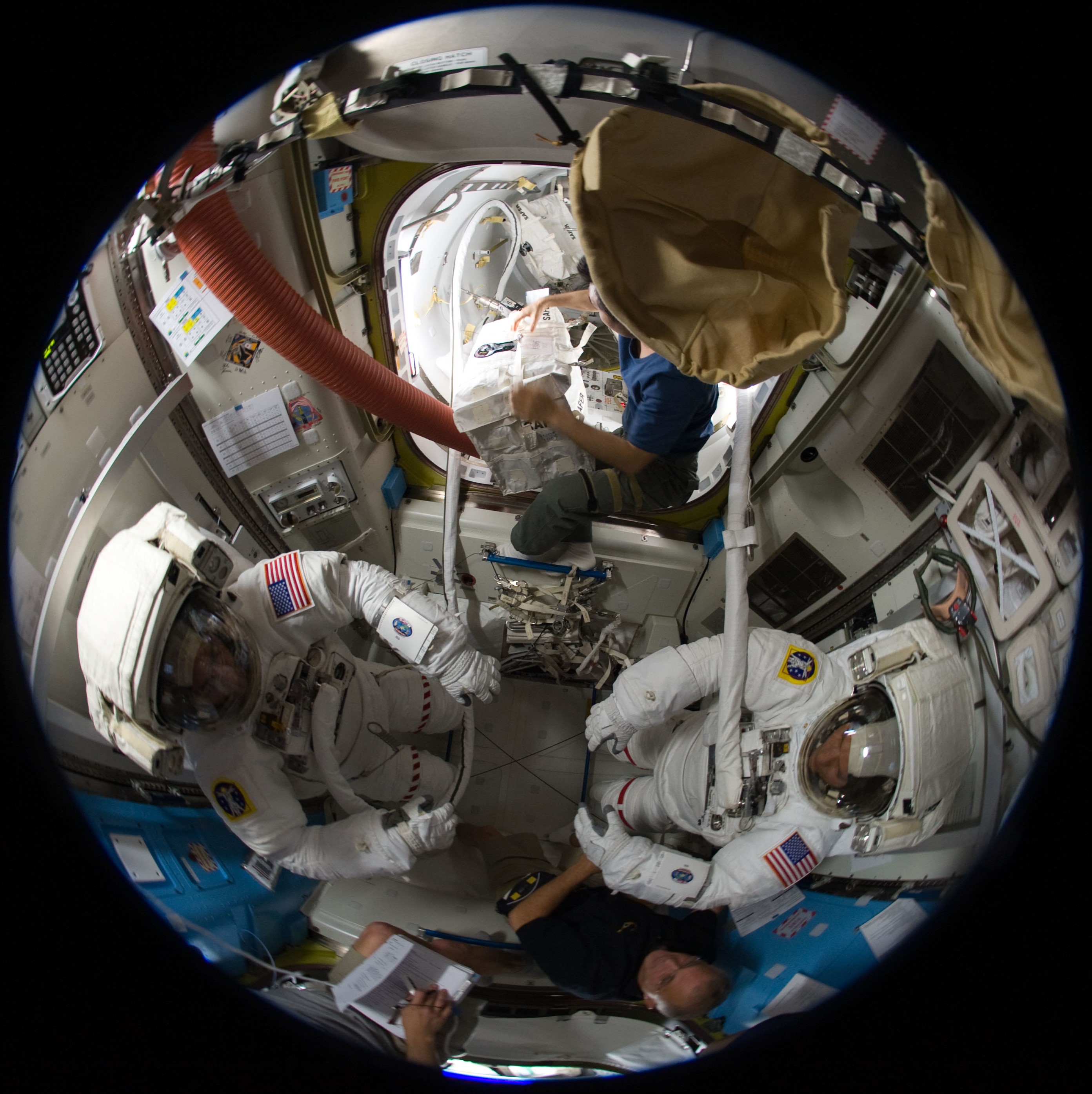 Fisheye view of Christopher J. Cassidy, left, and Thomas H. Marshburn in the U.S. Airlock preparing for the mission’s fifth and final spacewalk