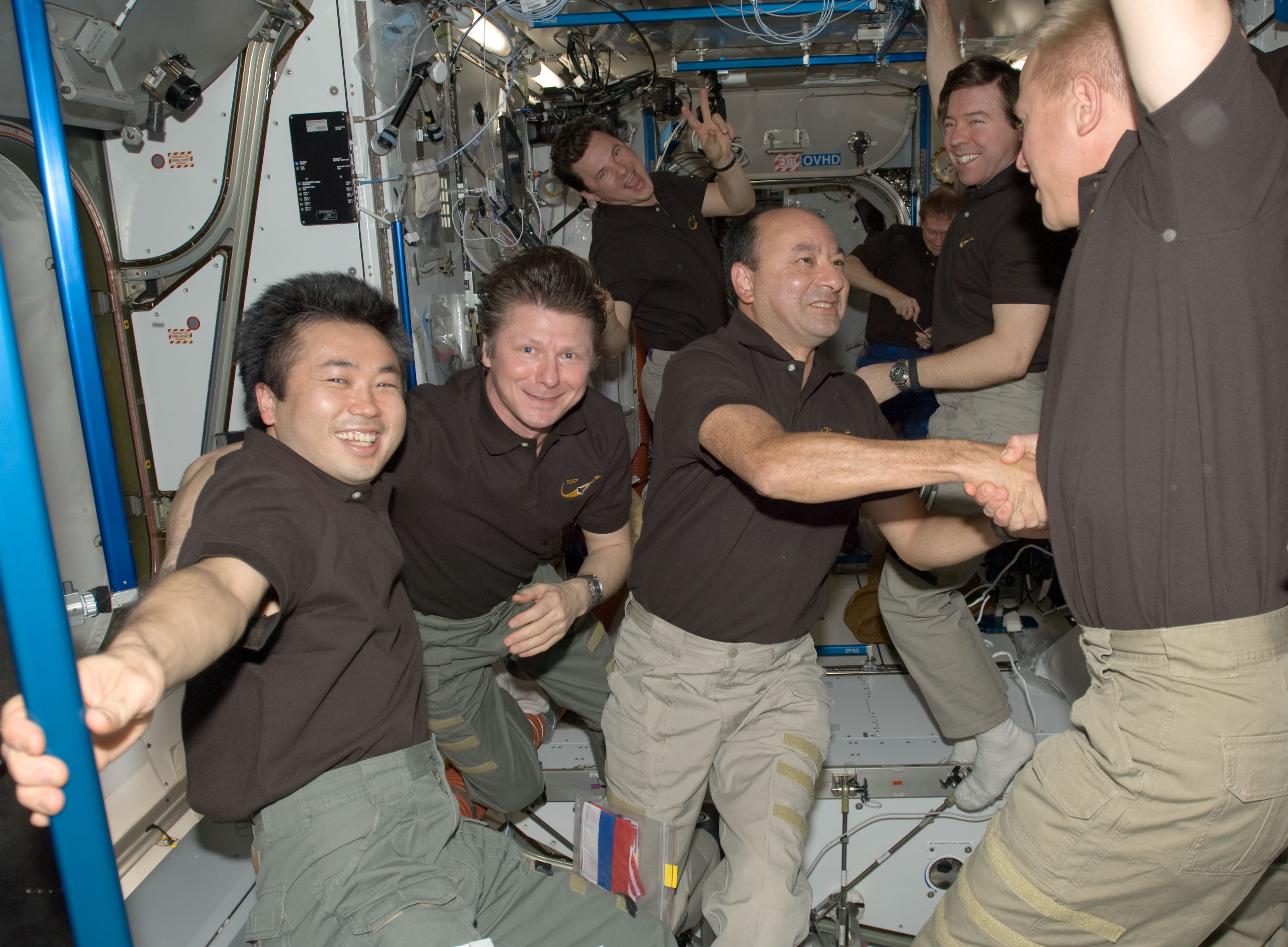 The crew members exchange farewells, with Koichi Wakata of the Japan Aerospace Exploration Agency, left, appearing a little reluctant to leave after spending 133 days aboard the space station