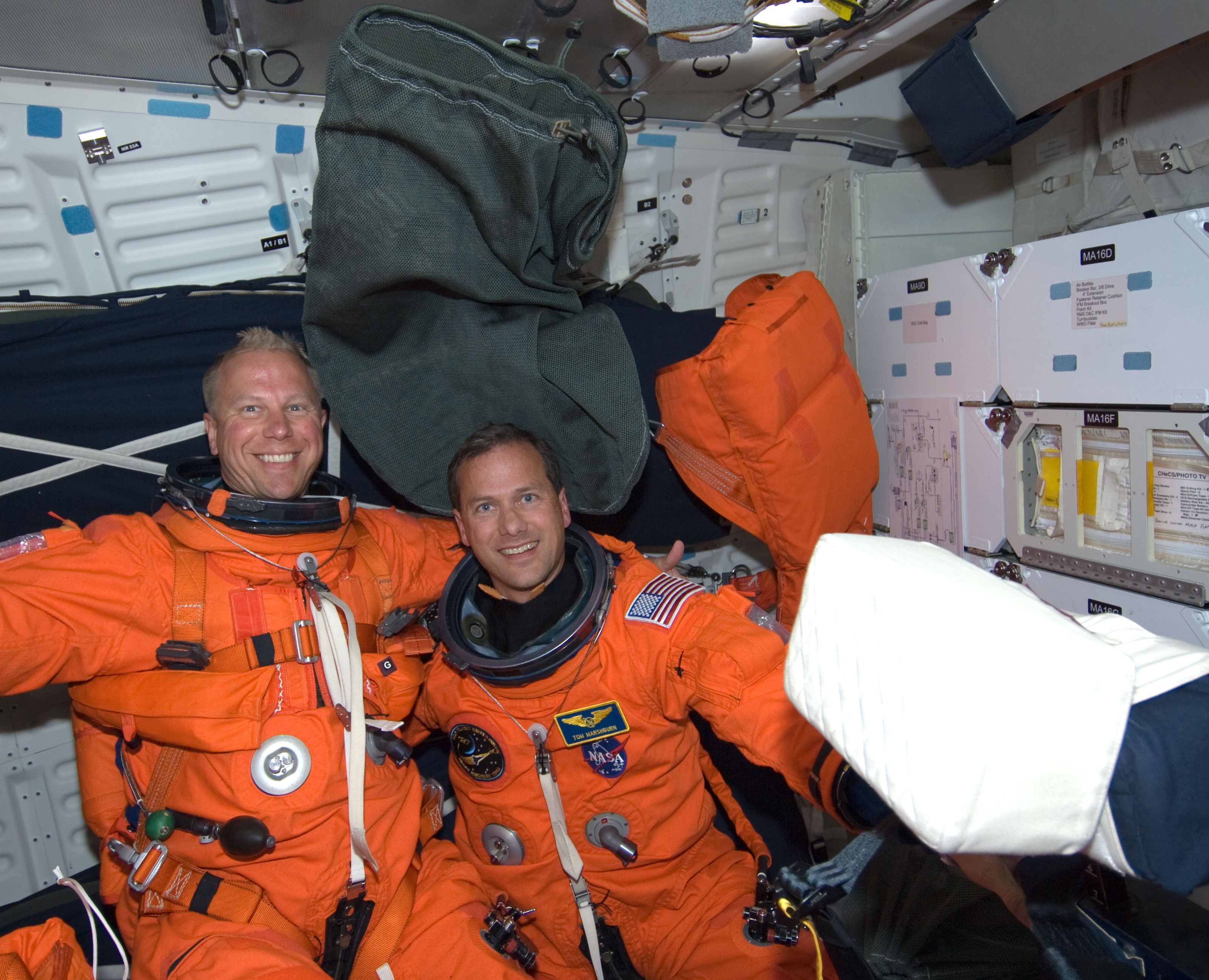 NASA astronauts Timothy L. Kopra, left, and Thomas H. Marshburn enjoy the first few minutes of weightlessness after Endeavour reached orbit