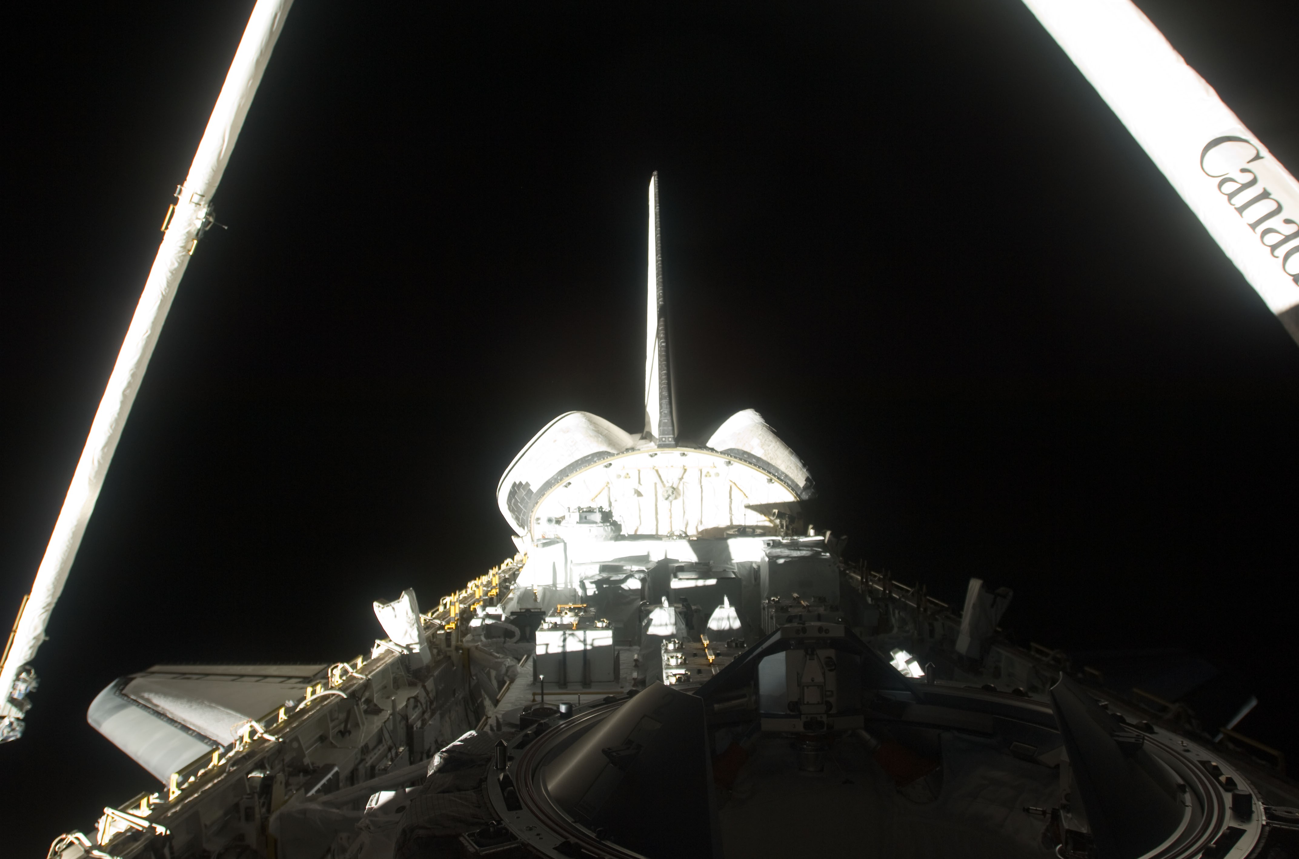 On the mission’s second day, the Shuttle Remote Manipulator System (SRMS) uses the Orbiter Boom Sensor System to image Endeavour’s Thermal Protection System (TPS)