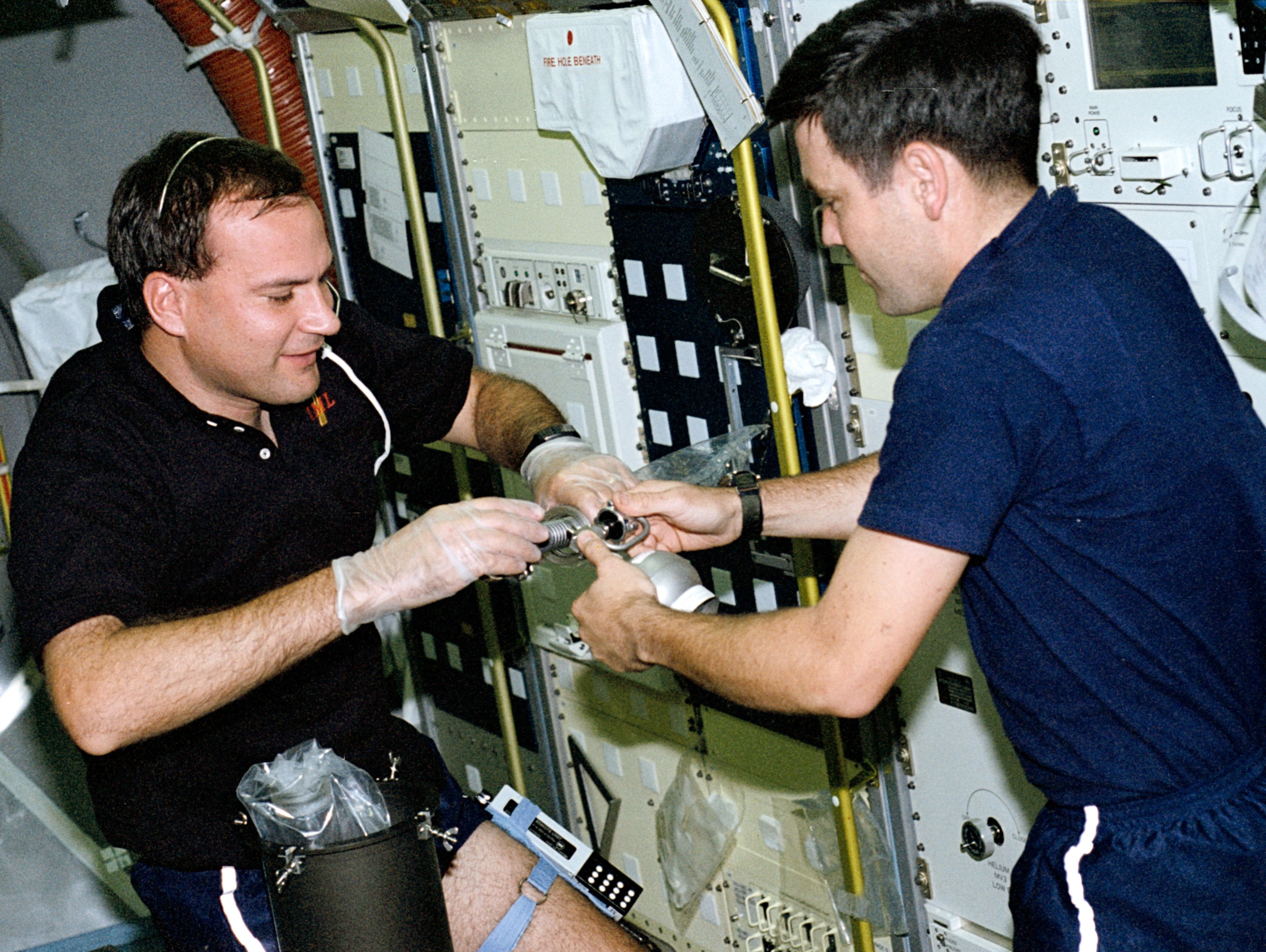Richard J. Hieb, left, and Robert D. Cabana take an air sample from an experiment