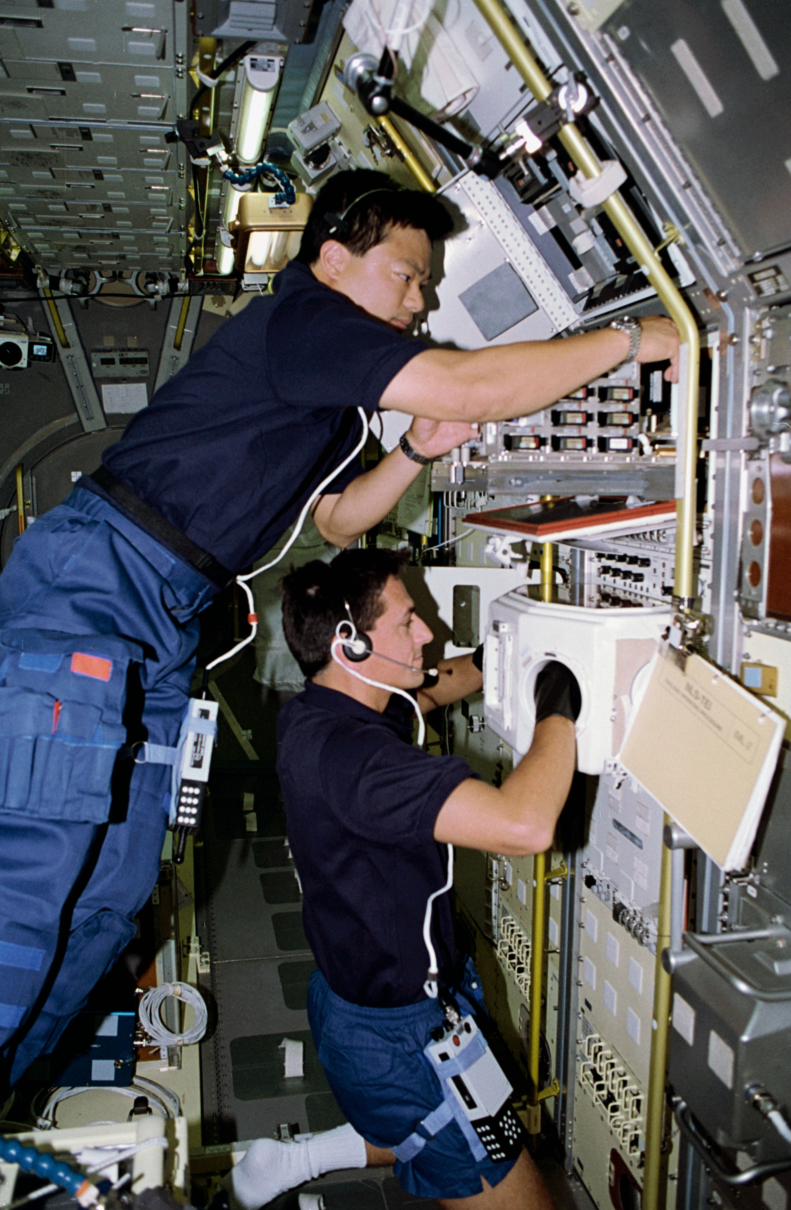 Chiao, left, and Thomas work on the Biorack instruments
