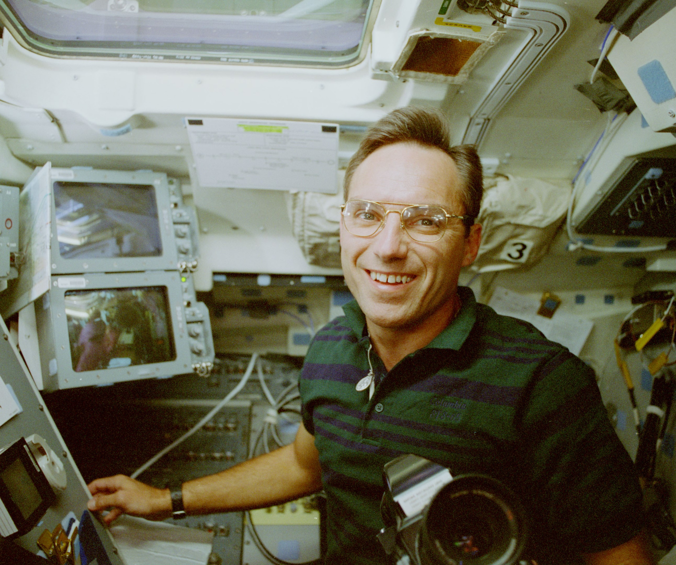 Carl E. Walz working on the shuttle's flight deck