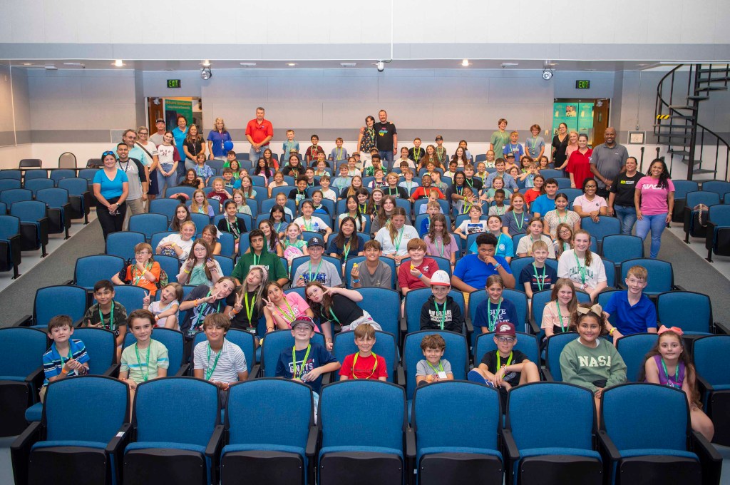 Take Our Children to Work Day participants sit for a photo in the StenniSphere auditorium