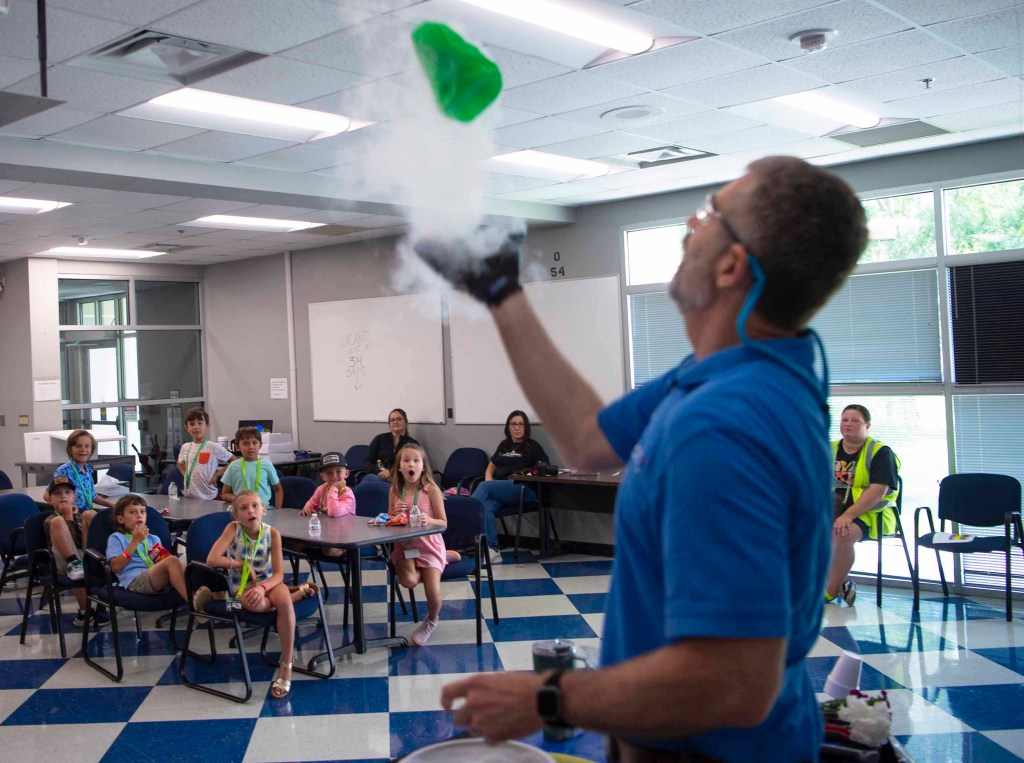 A group of Take Our Children Day participants watch a cryogenic demonstration led by Allen Forsman