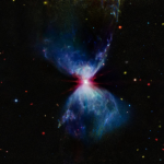L1527, shown in this image from NASA’s James Webb Space Telescope’s MIRI (Mid-Infrared Instrument), is a molecular cloud that harbors a protostar. It resides about 460 light-years from Earth in the constellation Taurus. The more diffuse blue light and the filamentary structures in the image come from organic compounds known as polycyclic aromatic hydrocarbons (PAHs), while the red at the center of this image is an energized, thick layer of gases and dust that surrounds the protostar. The region in between, which shows up in white, is a mixture of PAHs, ionized gas, and other molecules. This image includes filters representing 7.7 microns light as blue, 12.8 microns light as green, and 18 microns light as red.
