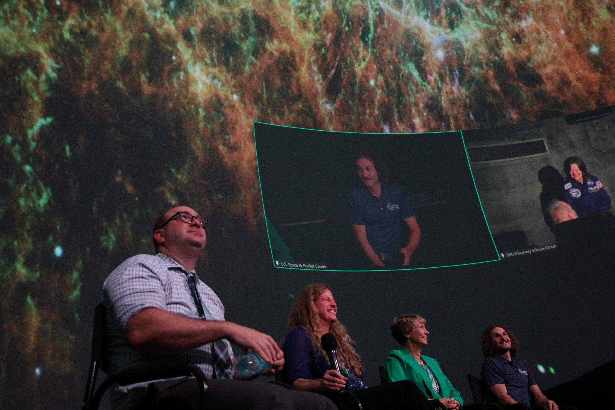 The program for the event celebrating 25 years of the agency’s Chandra X-ray Observatory at the U.S. Space & Rocket Center’s Intuitive Planetarium on Aug. 23 was hosted by David Weigel, bottom right, director of the U.S. Space & Rocket Center’s Intuitive Planetarium. Former NASA astronaut Cady Coleman, top right, joined the panel virtually to share her experience as a mission specialist on STS-93, which deployed the iconic space telescope. Collins joined STS-93 as the first woman to command a space shuttle mission. Together, the two former astronauts gave first-hand accounts of their journey aboard space shuttle Columbia.