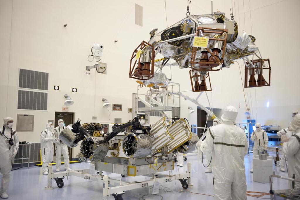 The rocket-powered descent stage guided over the rover by technicians