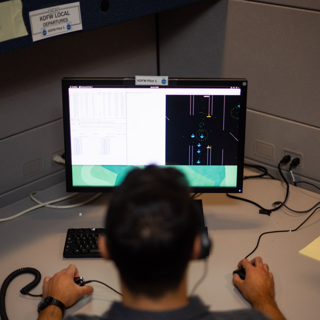 A pseudo-pilot wearing a headset operates a computer console. The display shows several aircraft icons.