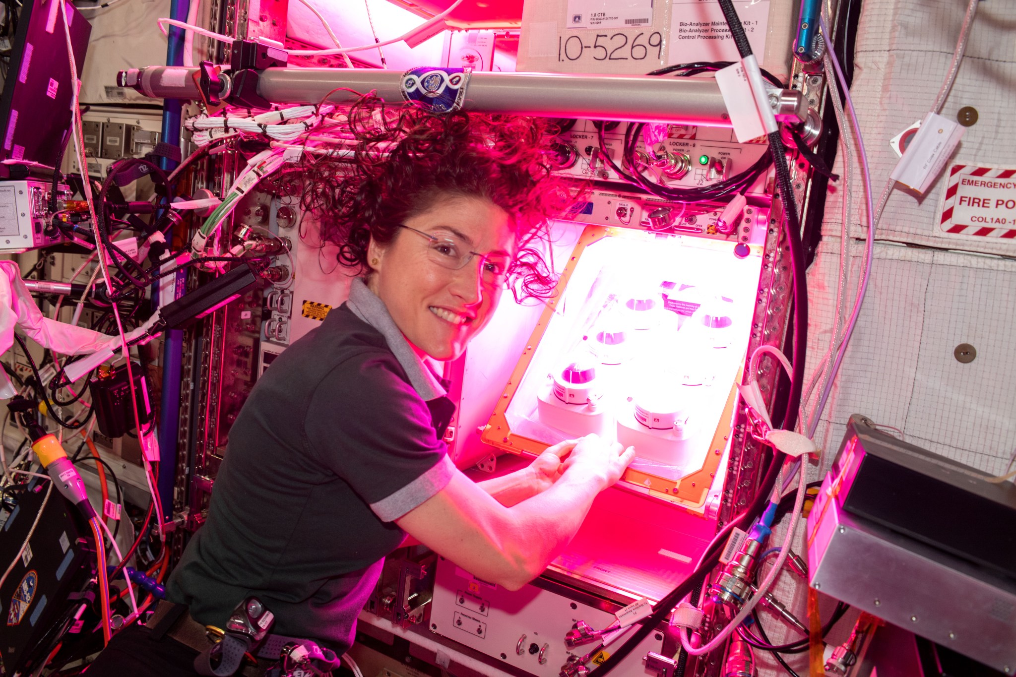 NASA astronaut Christina Koch initiates the Veg-PONDS-02 experiment on the International Space Station within Veggie by filling the upper reservoir on April 25, 2019.