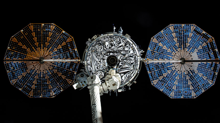 The Cygnus space freighter with its two cymbal-shaped solar arrays is pictured attached to the Canadarm2 robotic arm before its release from the space station's on July 12, 2024.