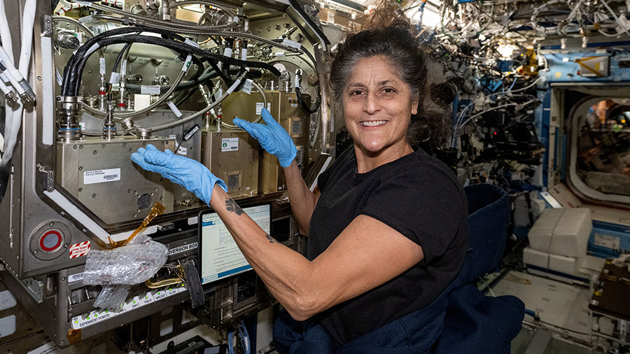 NASA astronaut Suni Williams installs experimental life support hardware inside the Microgravity Science Glovebox located inside the Destiny laboratory module.