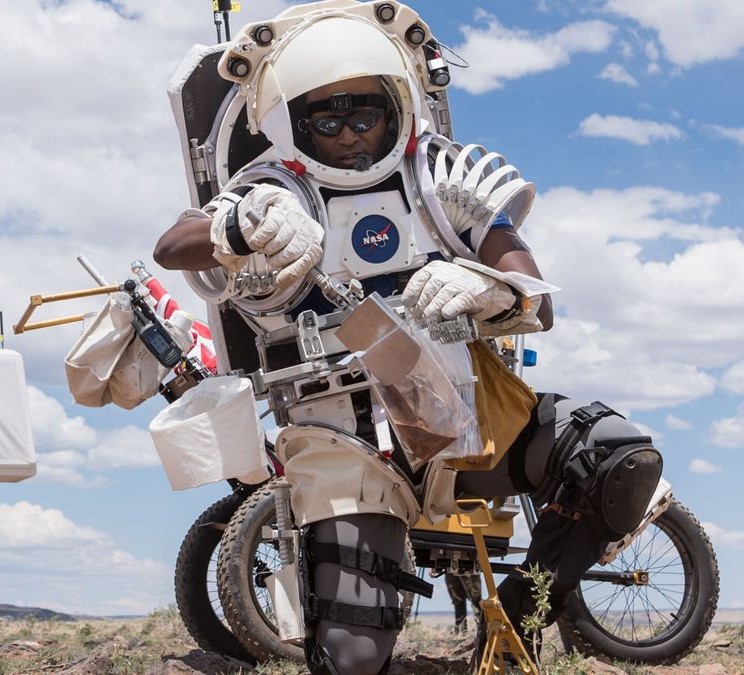 Douglas collects soil samples during simulated moonwalks in Northern Arizona in May 2024