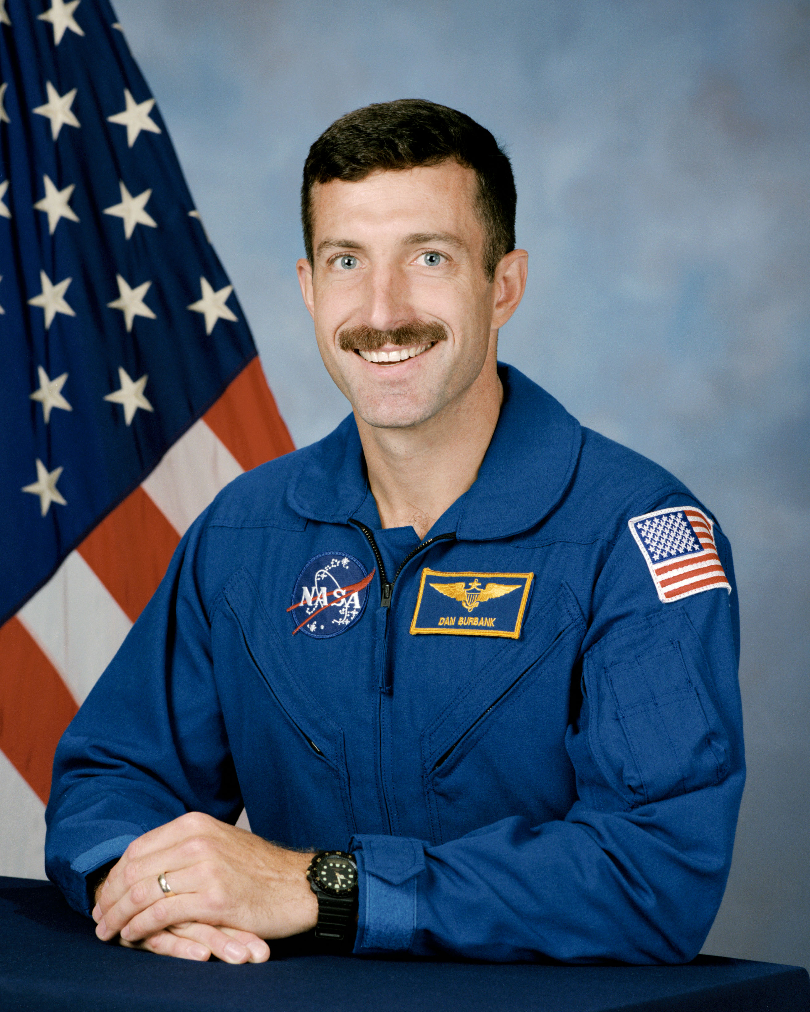 Official astronaut portrait of Daniel C. Burbank, Class of 1996. Middle left: Burbank installs the Elektron oxygen generation unit in the Zvezda Service Module during STS-106