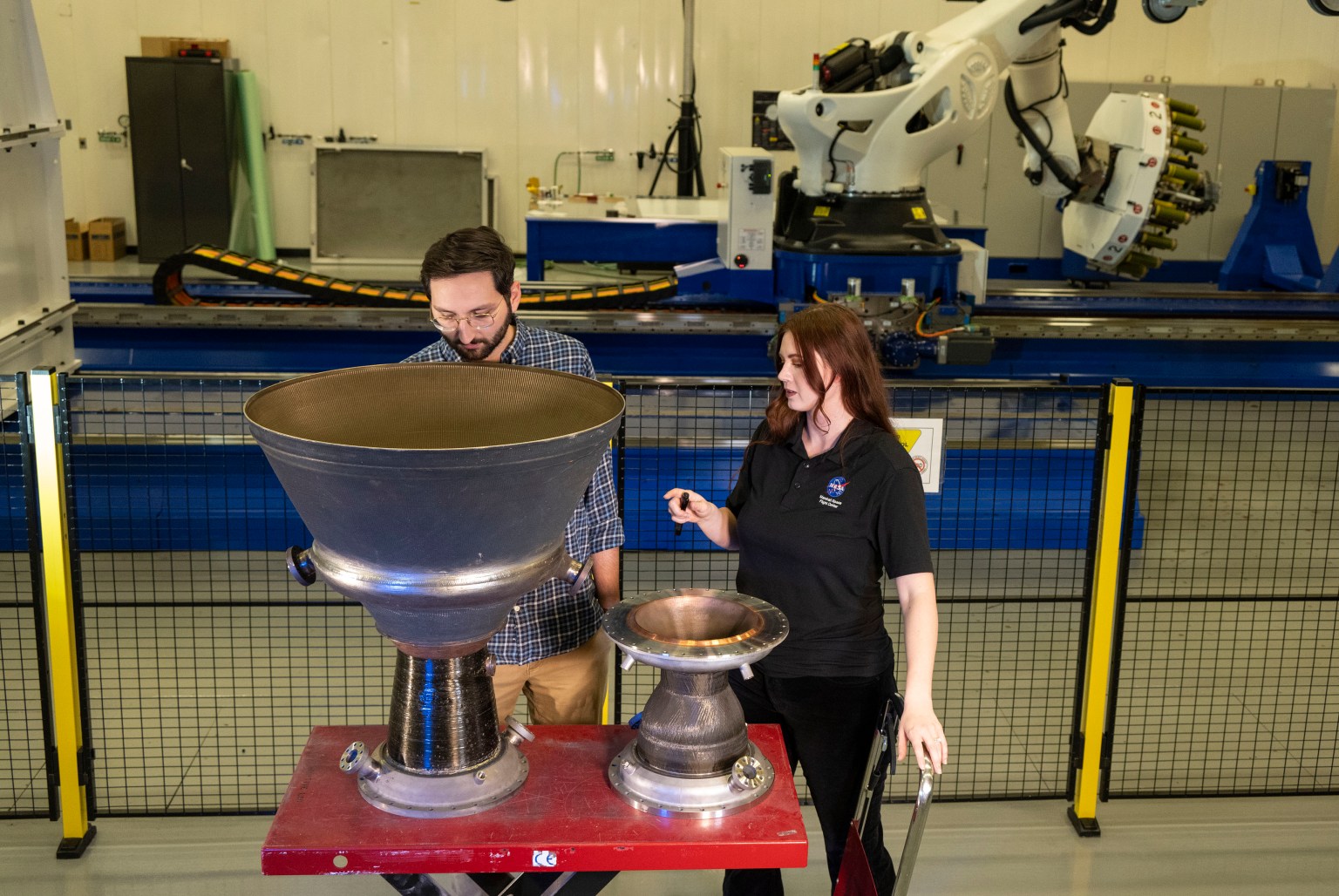 A man and women look at a piece of hardware