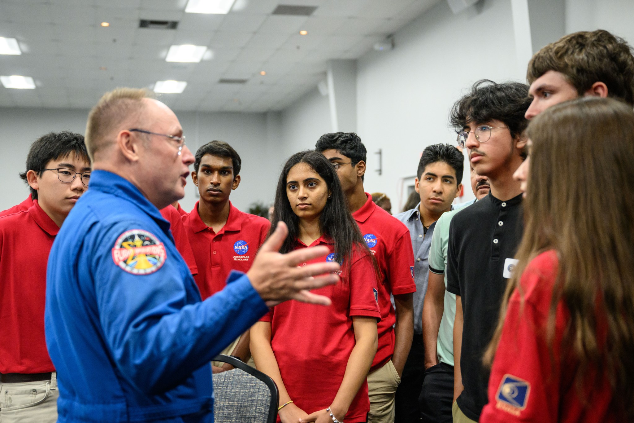 A NASA astronaut speaks to a group of high school students.