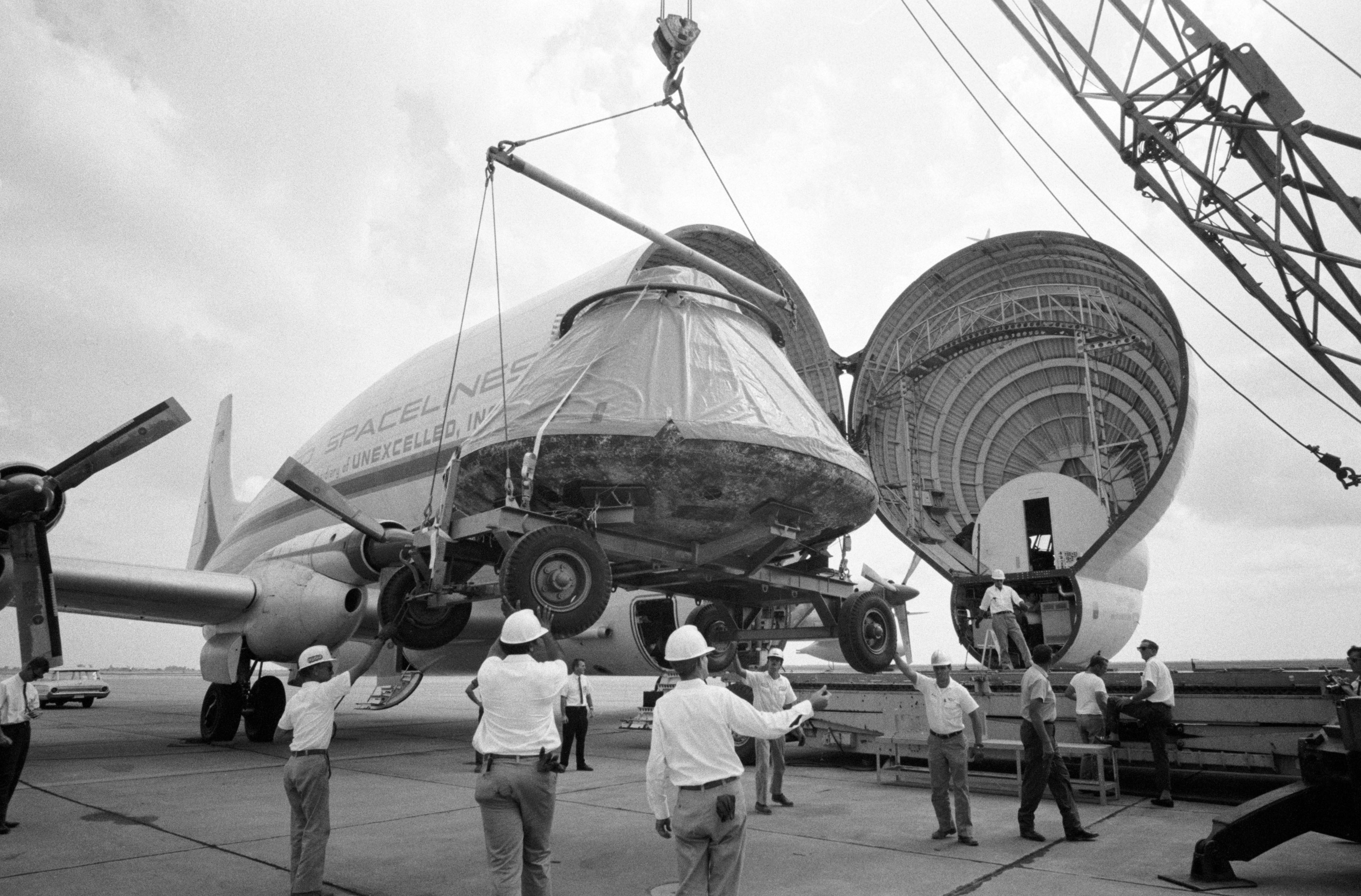 Workers load the Apollo 11 Command Module Columbia into a Super Guppy for transport to the North American Rockwell plant in Downey, California