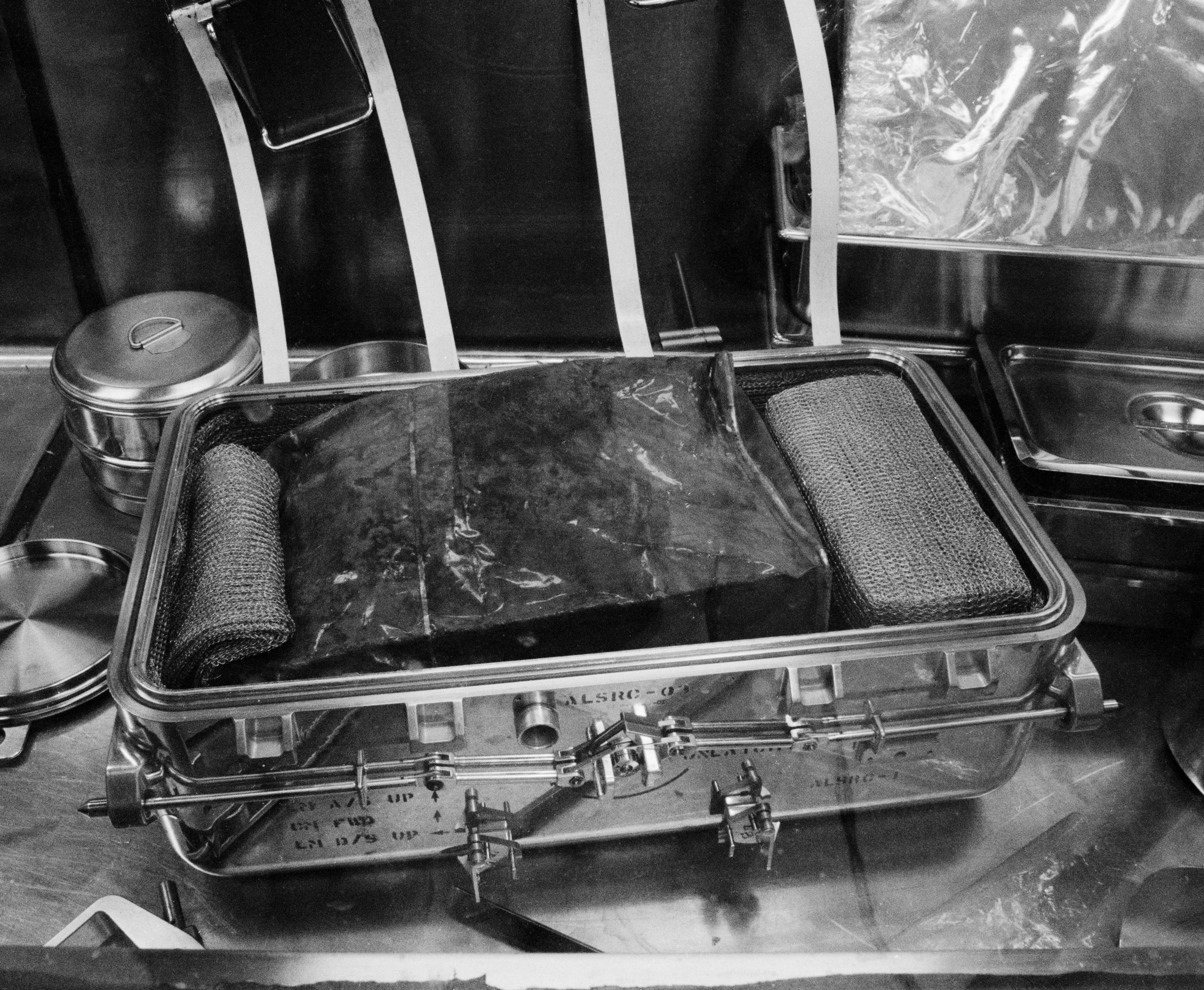 Aug. 5, 1969. In the Lunar Receiving Laboratory, scientists open the second Apollo 11 Lunar Sample Return Container and begin to examine the rock and soil samples