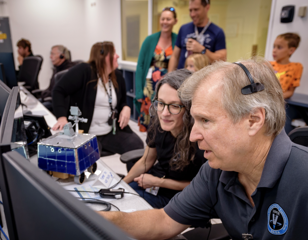 Right to left: Jay Trimble, Rachel Hoover, and Kelsey Herrmann in the Multi-Mission Operations Center (MMOC), N240, during the Volatiles Investigating Polar Exploration Rover (VIPER) Friends and Family Day.