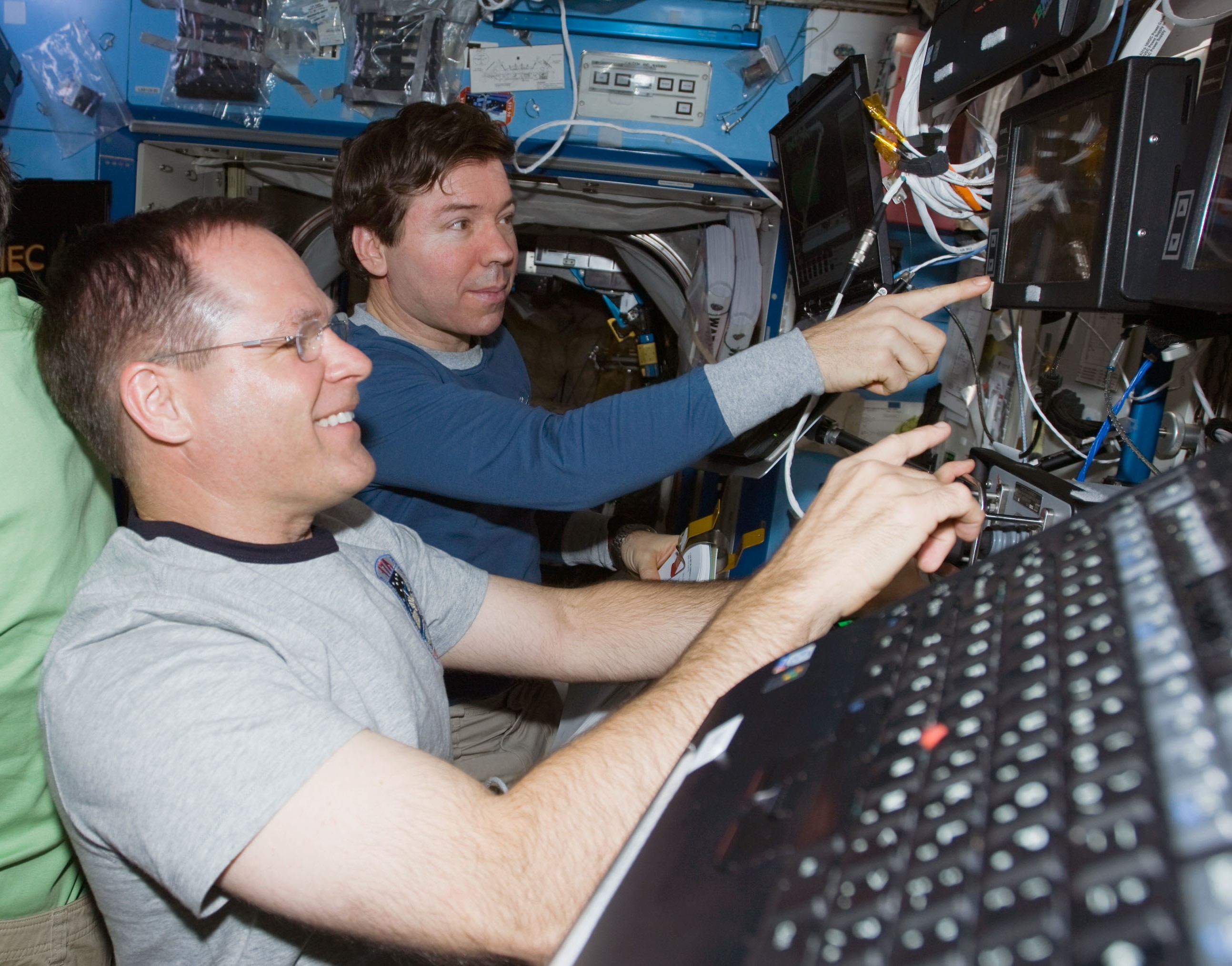 Kevin A. Ford, left, and Michael R. Barratt operate the station’s robotic arm