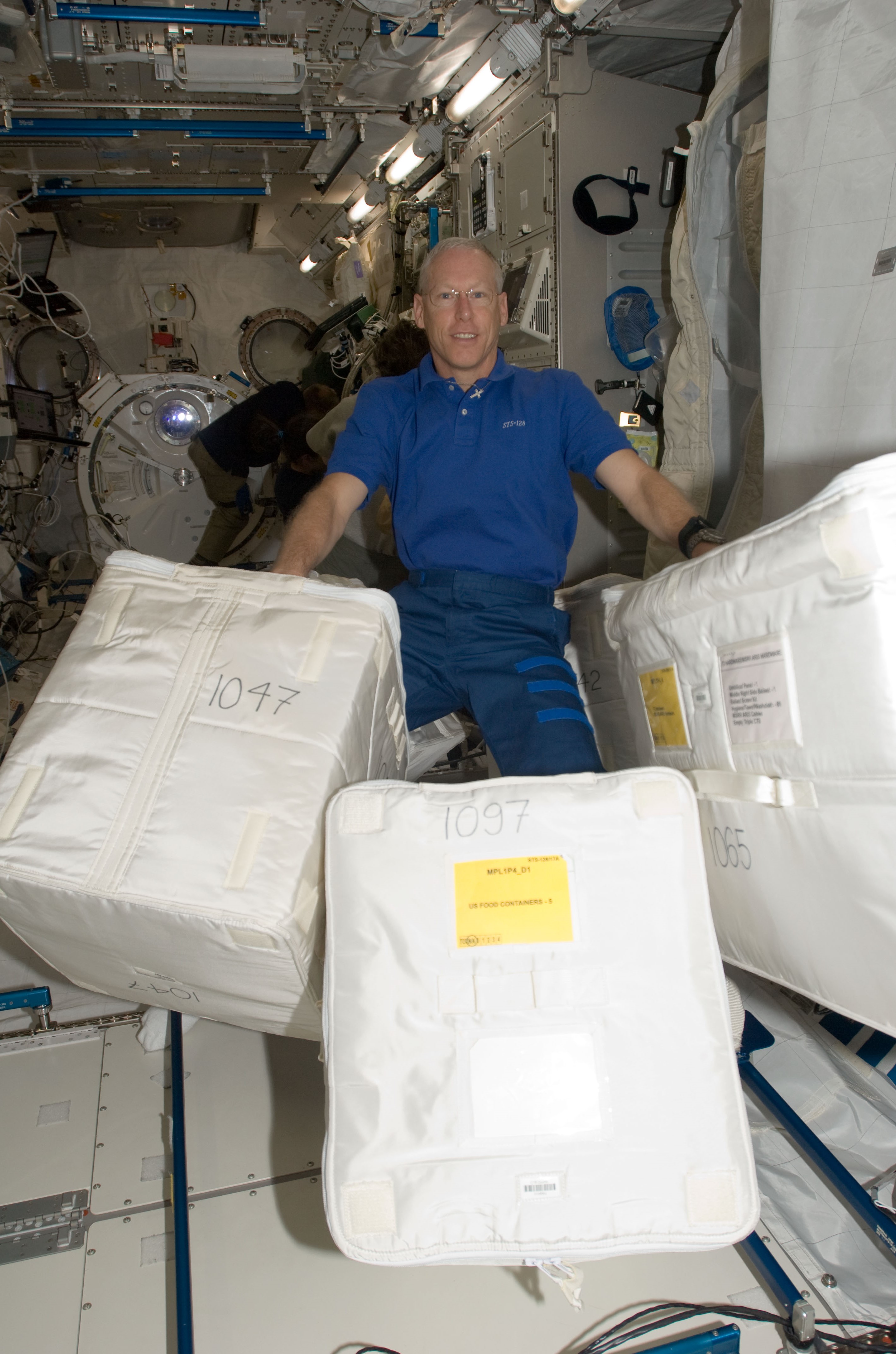 Patrick G. Forrester with three bags during cargo transfer operations