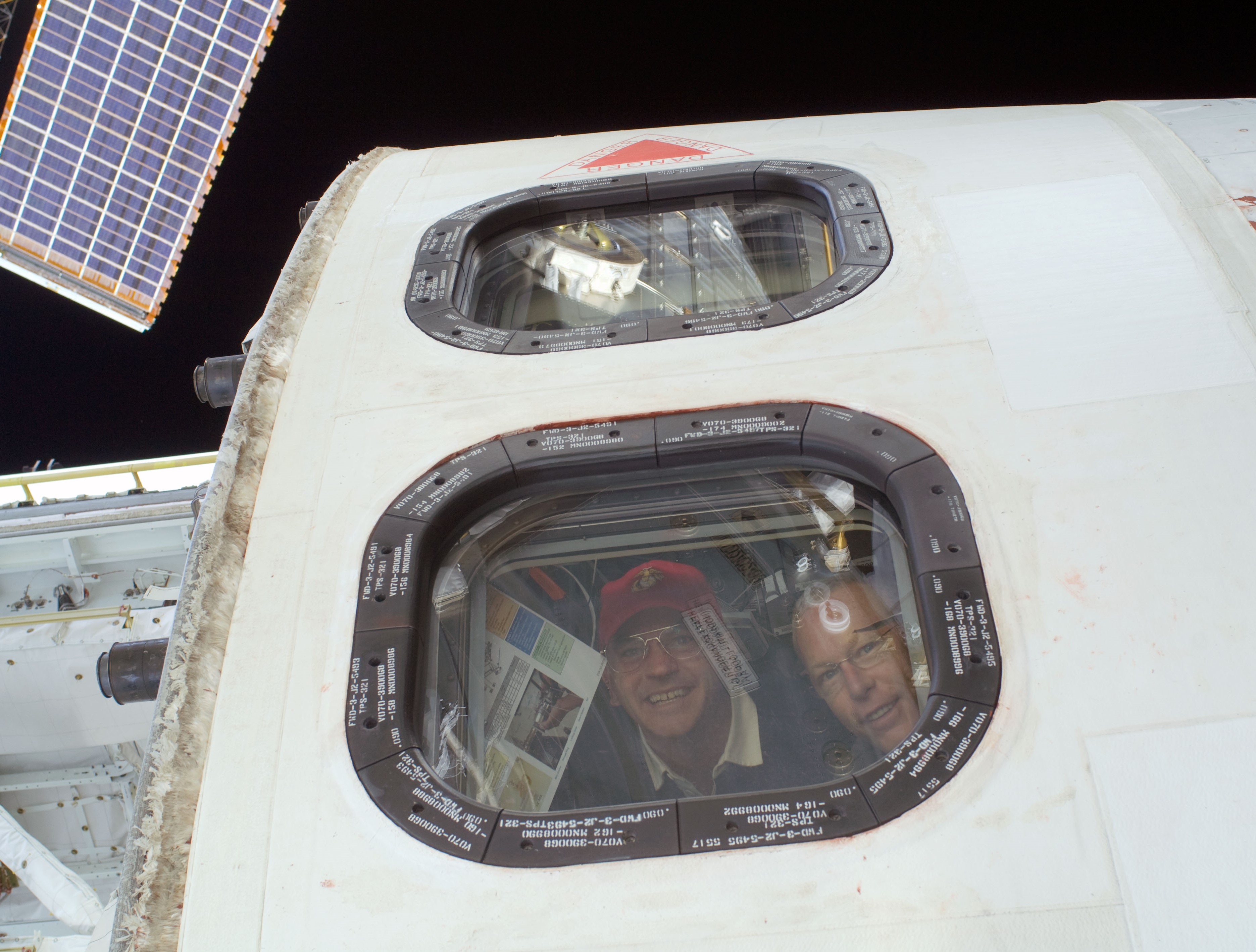 Frederick “Rick” W. Sturckow, left, and Patrick G. Forrester seen through an overhead window