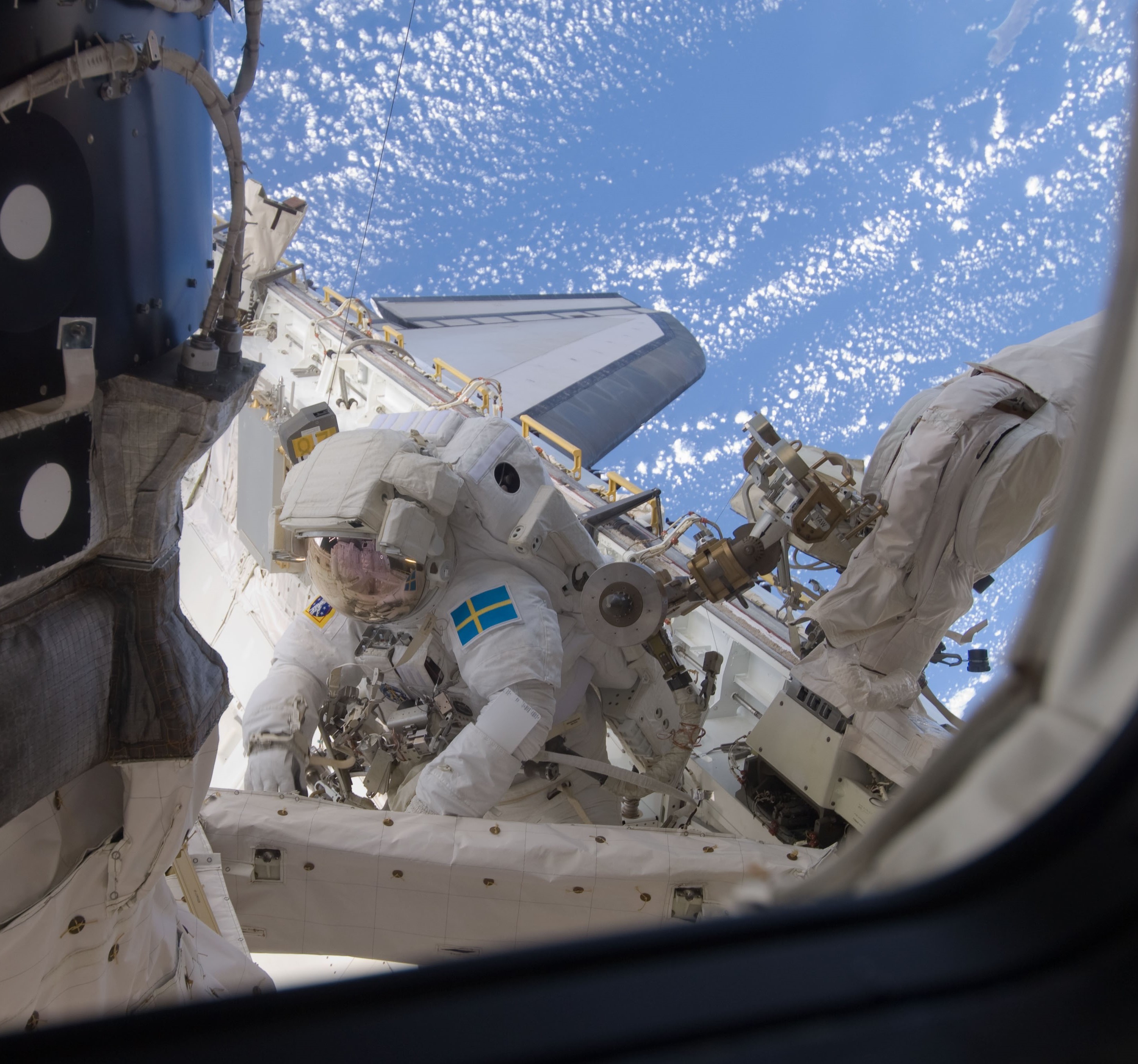 Fuglesang stowing the old ATA in the shuttle’s payload bay