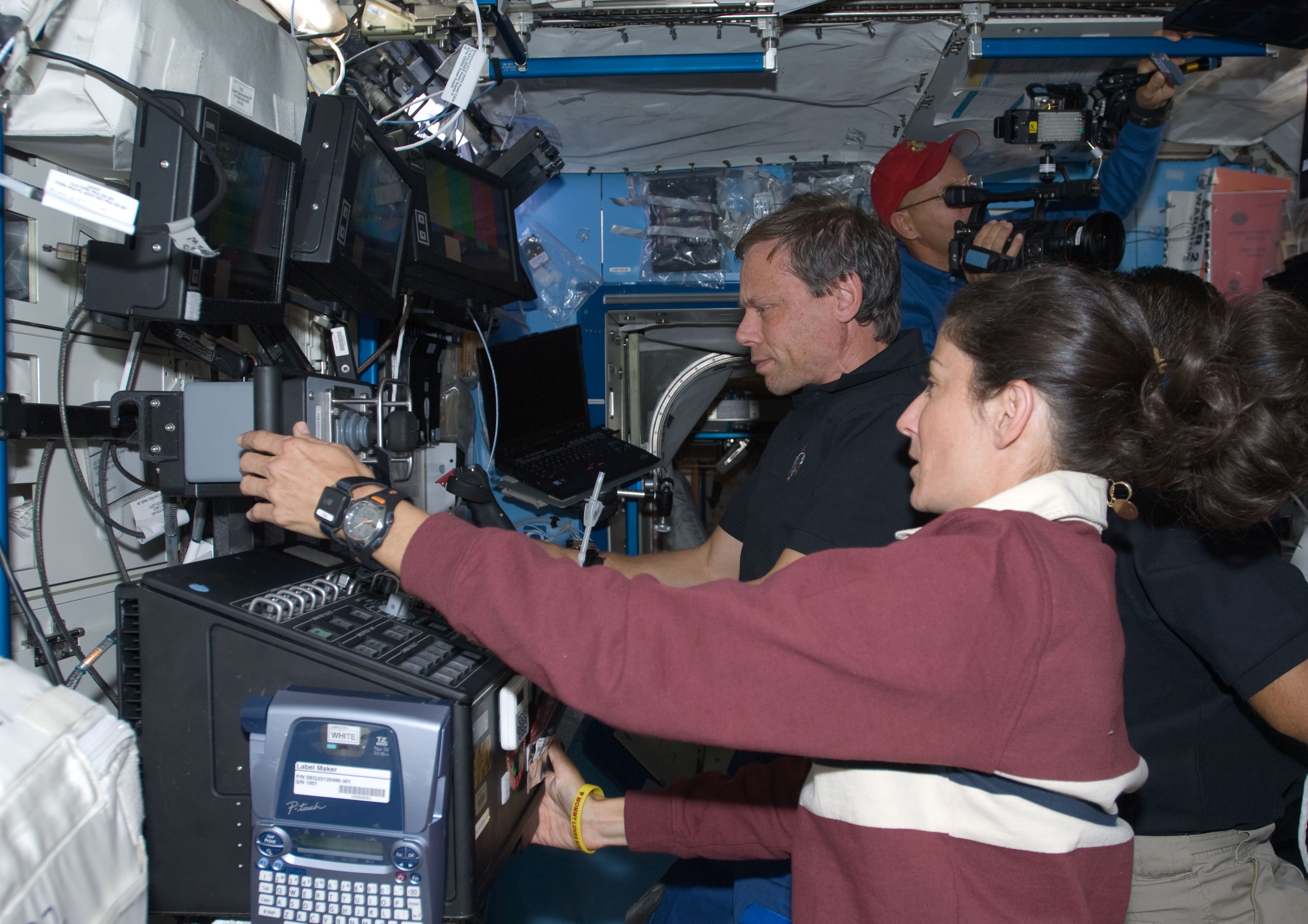 A. Christer Fuglesang, left, and Nicole P. Stott operate the space station's robotic arm