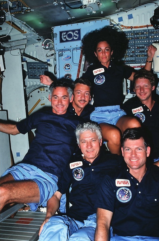 The STS-41D crew pose in Discovery’s middeck