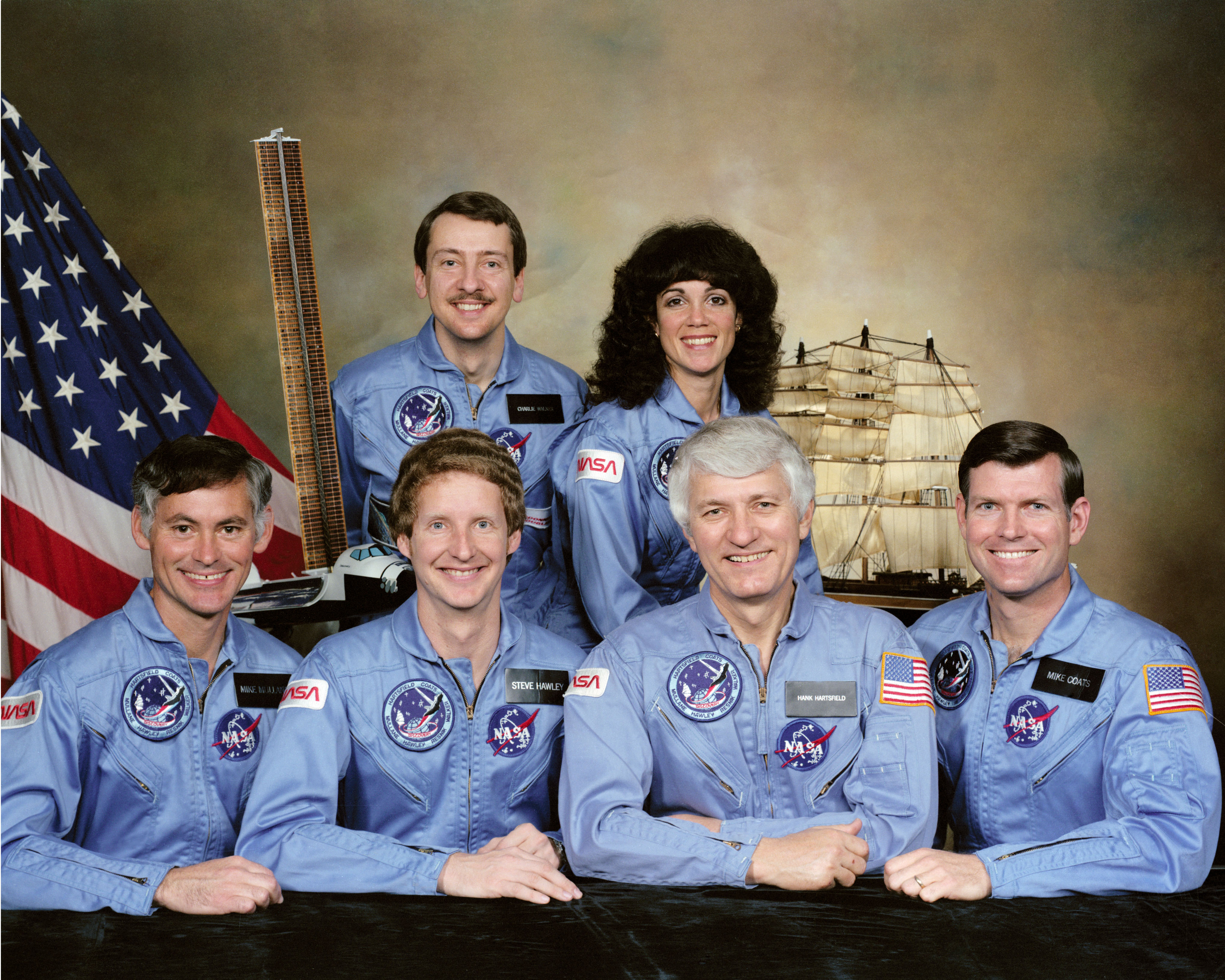 Official photograph of the STS-41D crew of R. Michael “Mike” Mullane, front row left, Steven A. Hawley, Henry “Hank” W. Hartsfield, and Michael L. Coats; Charles D. Walker, back row left, and Judith A. Resnik