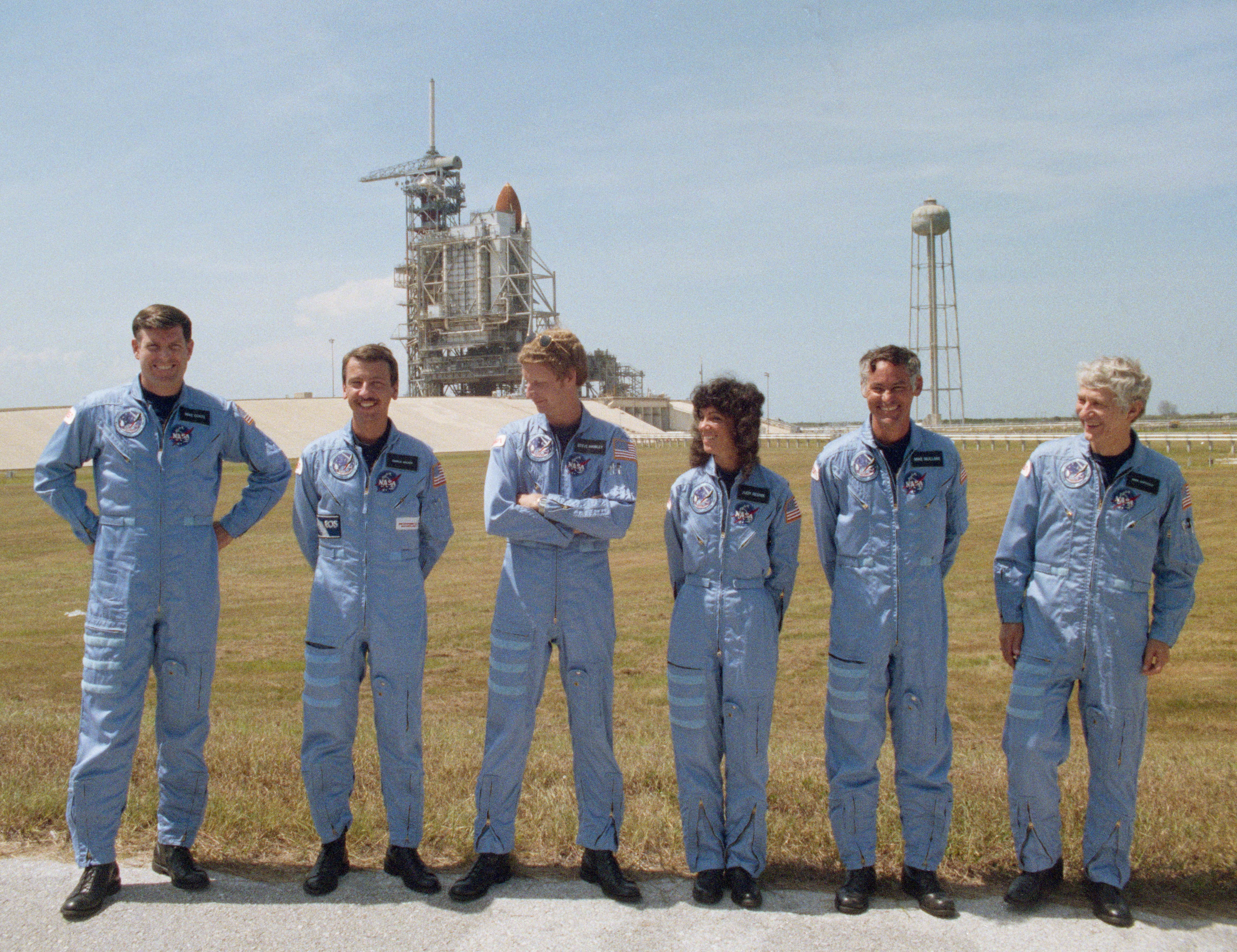 The STS-41D crew pose at Launch Pad 39A at NASA’s Kennedy Space Center in Florida following the Terminal Countdown Demonstration Test