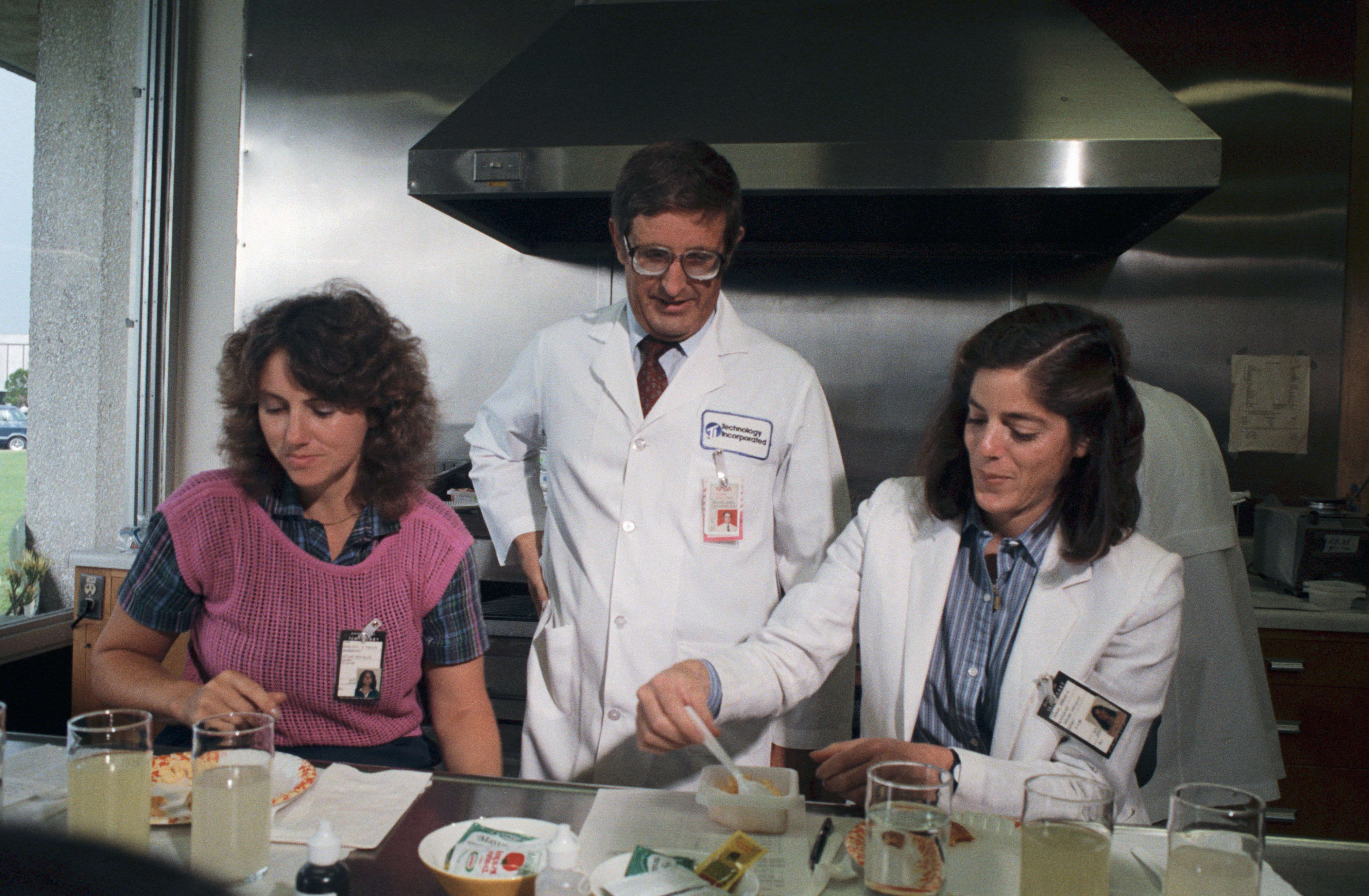 McAuliffe, left, and Morgan get their first taste of space food