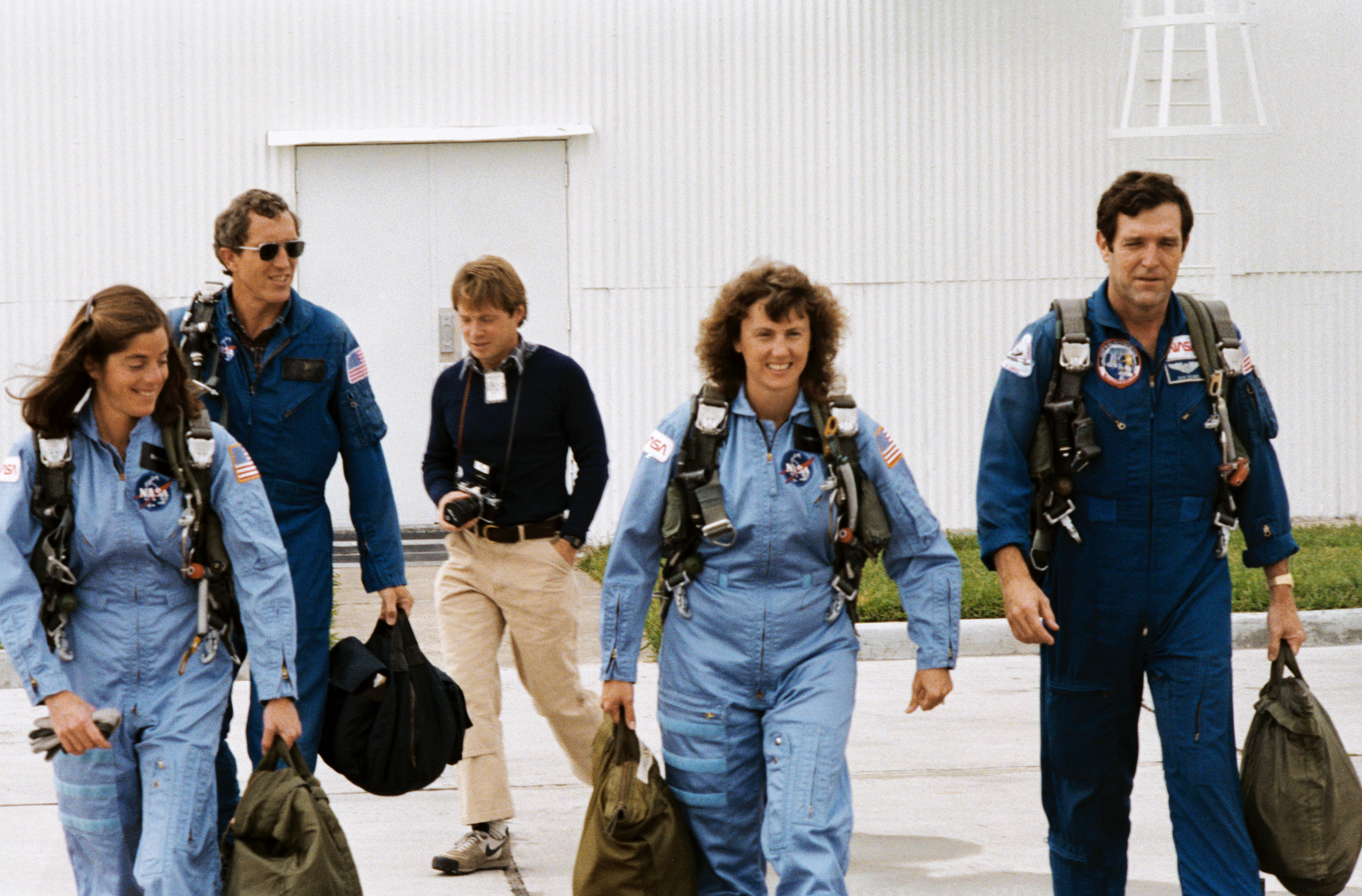 At Houston's Ellington Air Force Base, Barbara R. Morgan, Michael J. Smith, a photographer, S. Christa McAuliffe, and Francis R. 