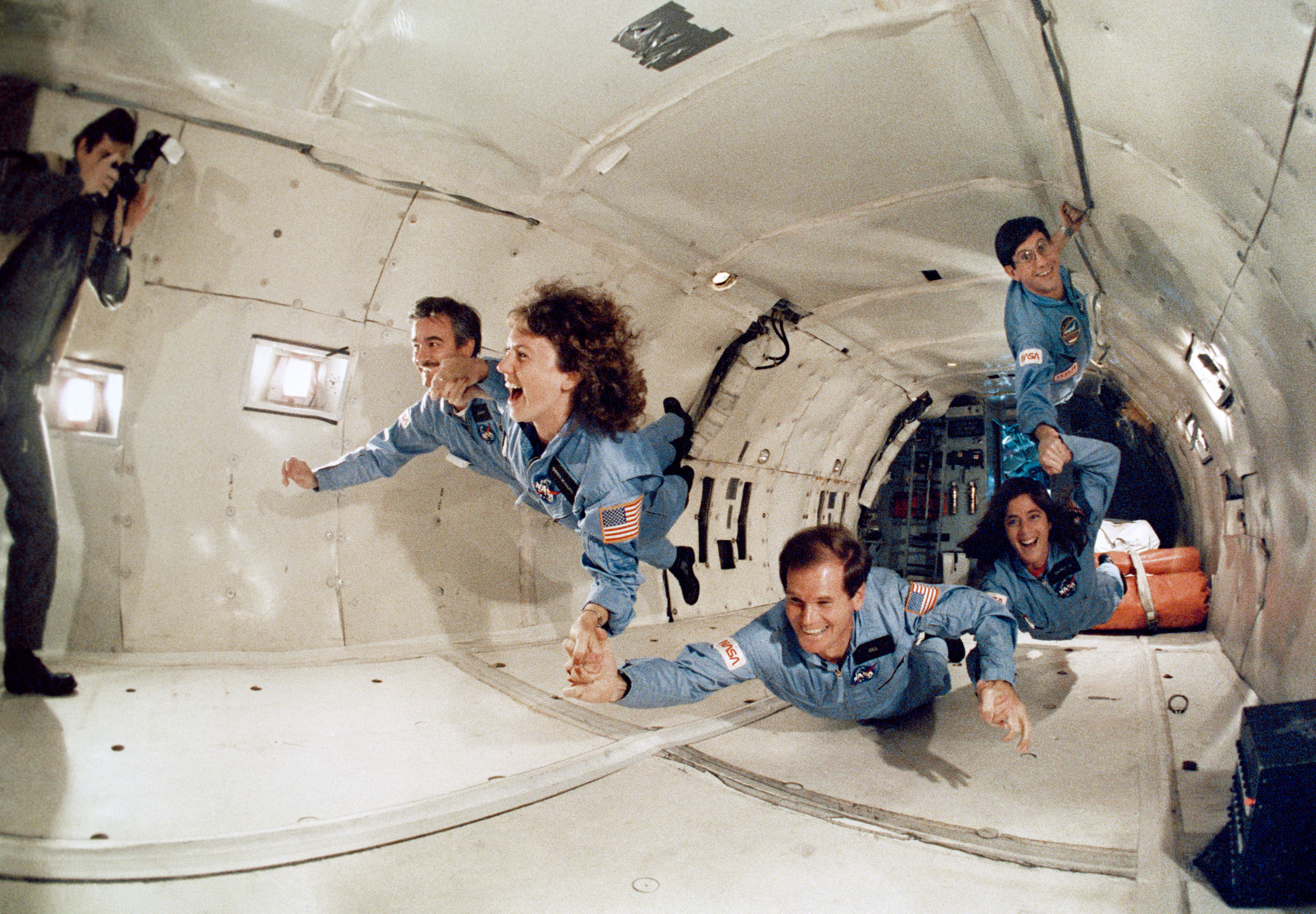 Teacher in Space McAuliffe, second from left, and her backup Morgan, get a taste of weightlessness aboard NASA's KC-135, along with STS-61C Payload Specialist Congressman C. William 