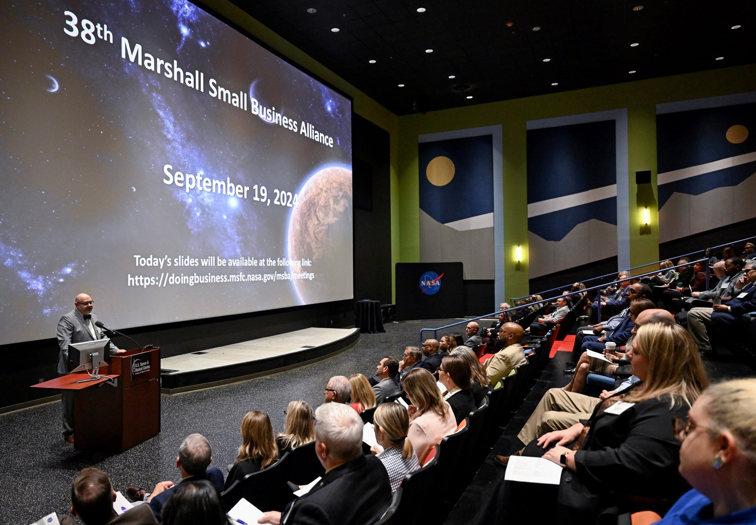 NASA Marshall Space Flight Center Director Joseph Pelfrey, bottom right, welcomes attendees to the 38th meeting of the Marshall Small Business Alliance on Sept. 19.