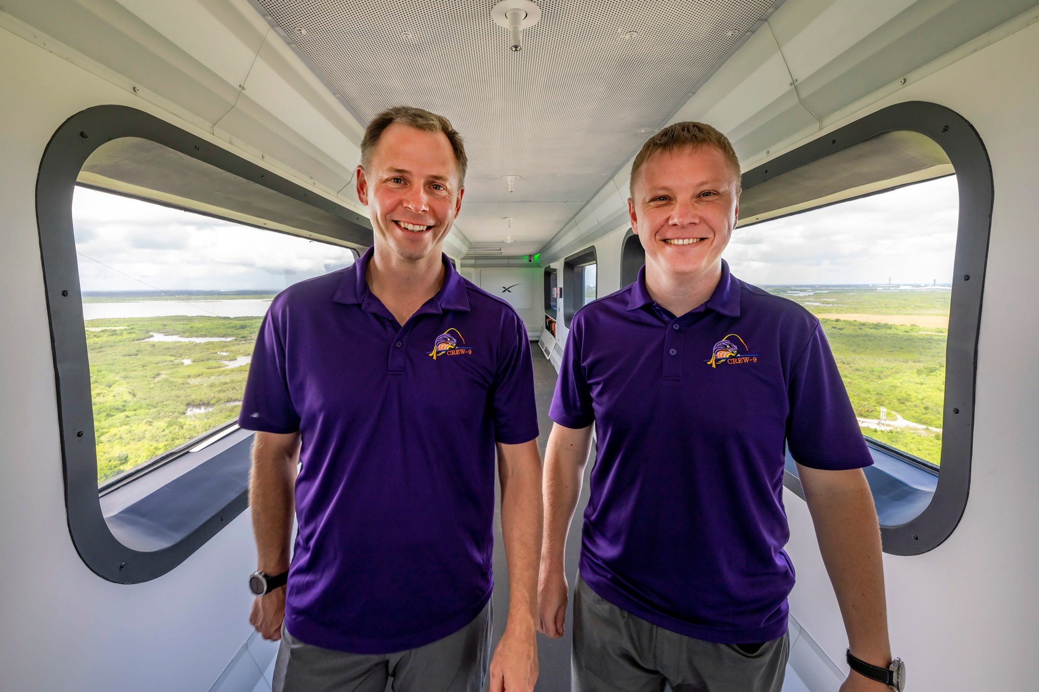 NASA astronaut Nick Hague and Roscosmos cosmonaut Aleksandr Gorbunov walk across the crew access arm at Space Launch Complex-40 at Cape Canaveral Space Force Station in Florida.