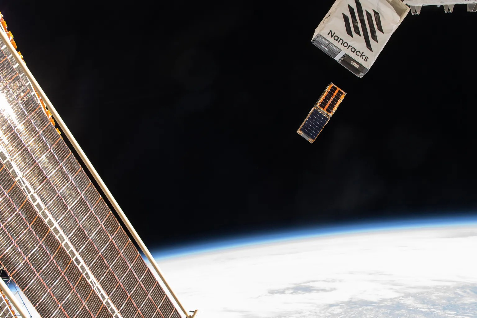 BurstCube, trailed by another CubeSat named SNOOPI (Signals of Opportunity P-band Investigation), emerges from the International Space Station on April 18.