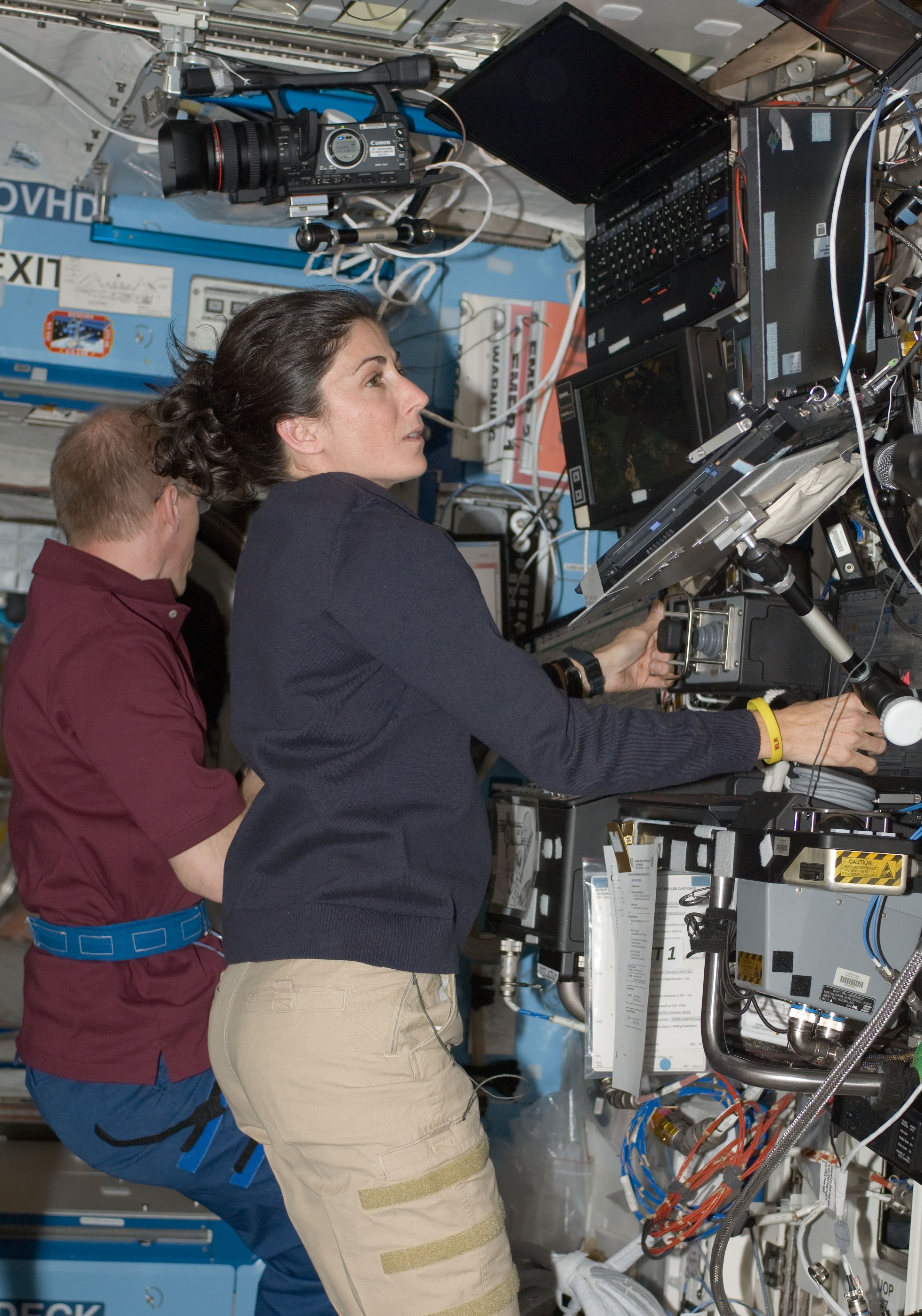 European Space Agency astronaut Frank DeWinne, left, and Stott operate the station’s robotic arm to grapple HTV-1 for release