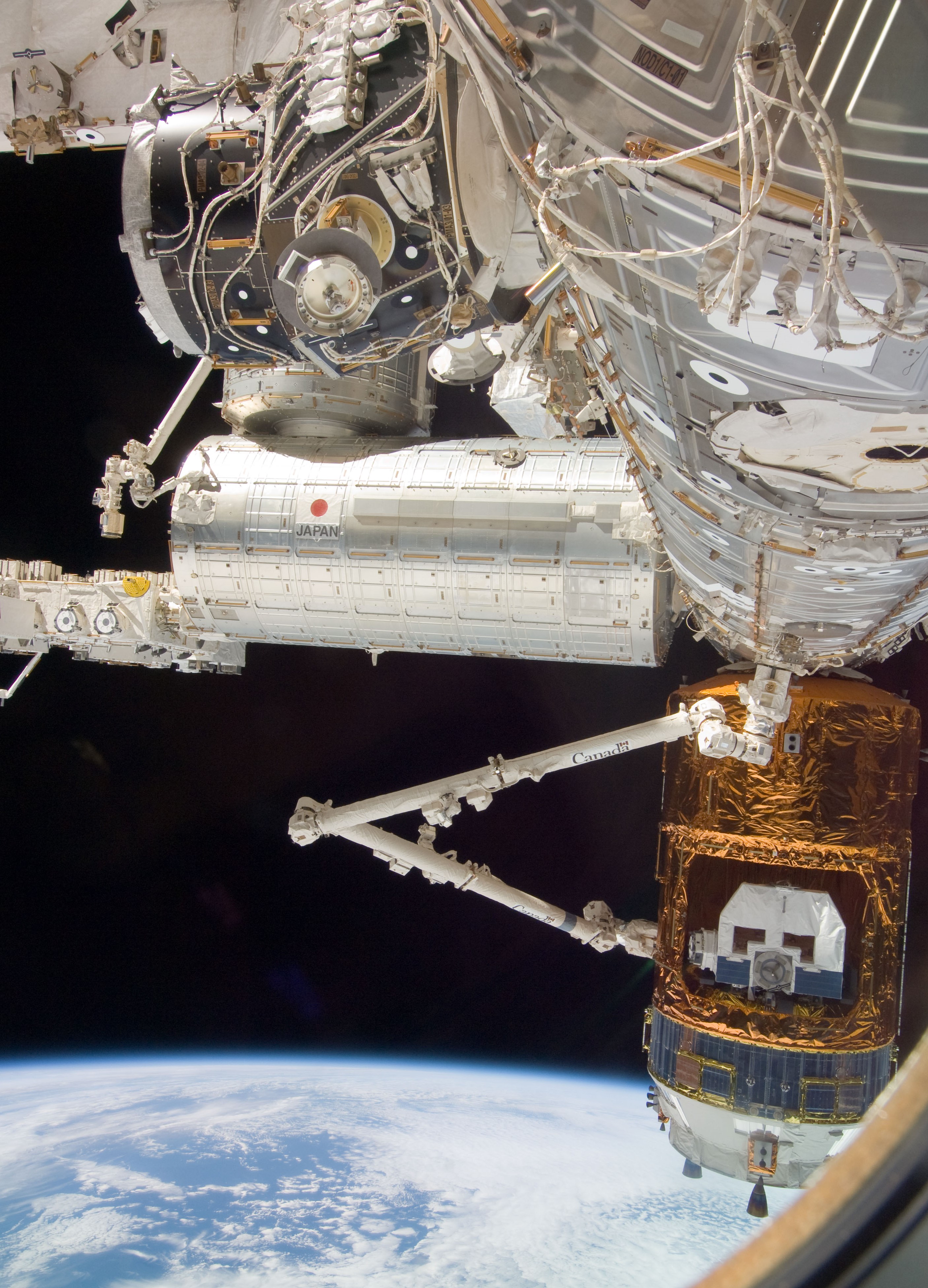 The space station’s robotic arm grapples HTV-1 in preparation for its unberthing