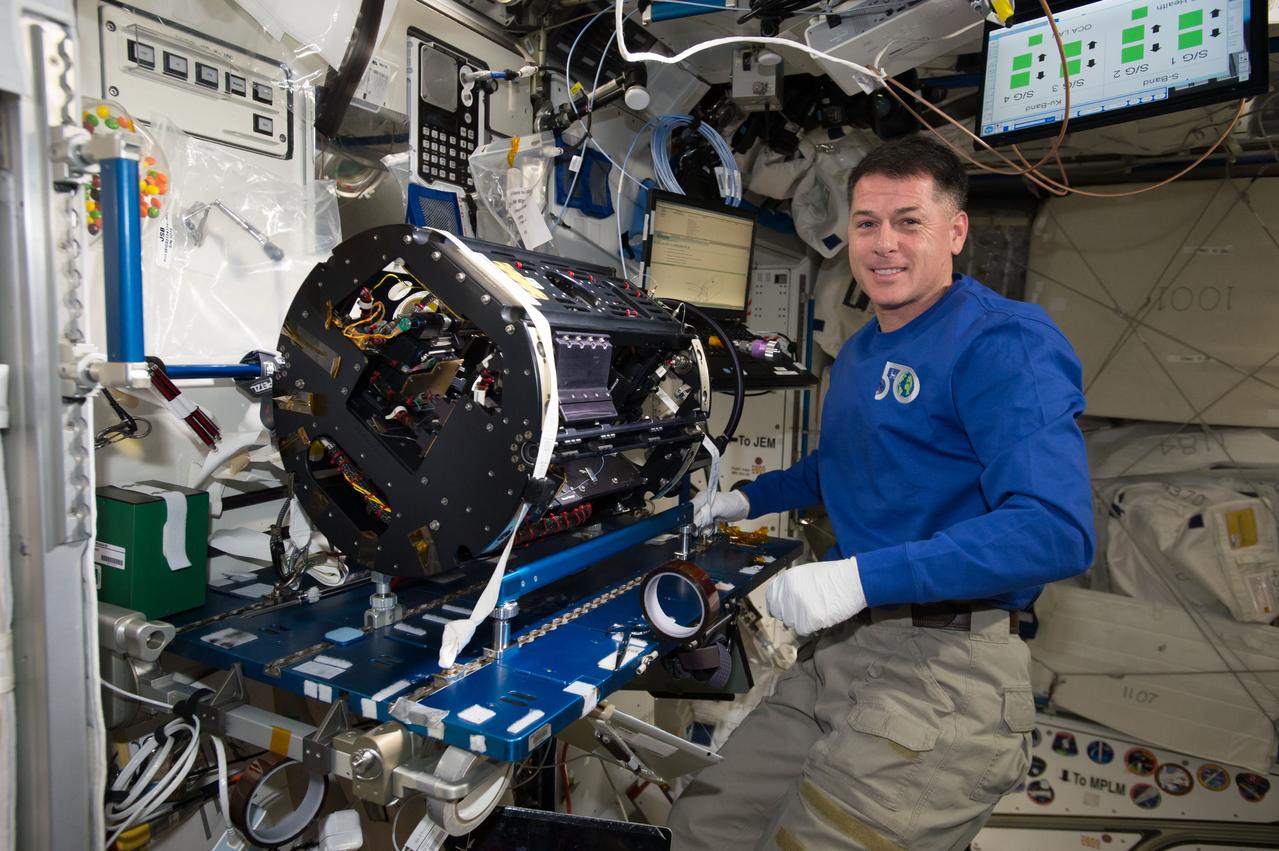 An astronaut conducts a Cool Flame investigation aboard the International Space Station, using the cylindrical Combustion Integrated Rack.